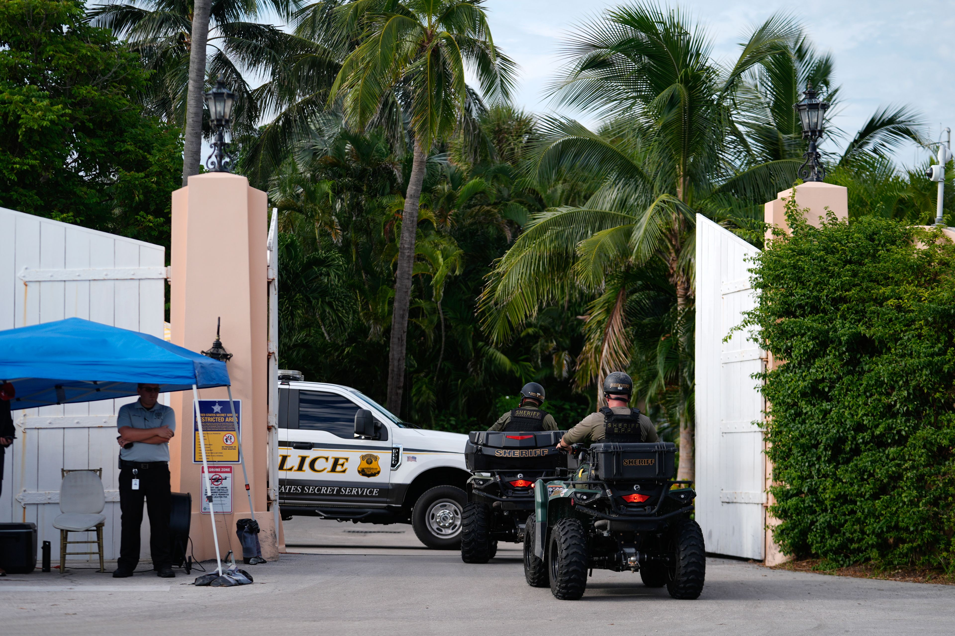 Police drive in to the Mar-a-Lago estate of Republican presidential nominee and former President Donald Trump, one day after an apparent assassination attempt, in Palm Beach, Fla., Monday, Sept. 16, 2024. (AP Photo/Rebecca Blackwell)