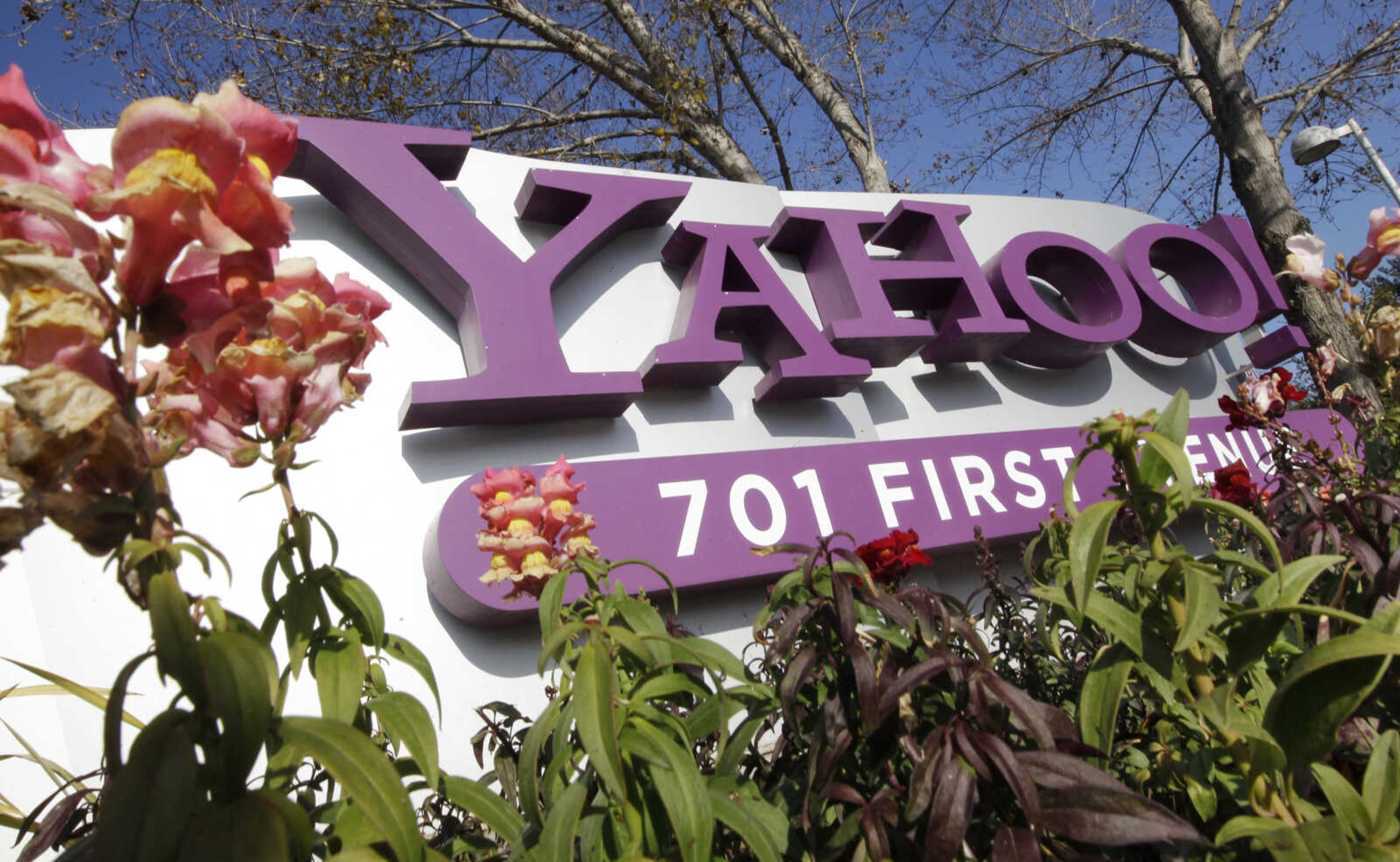 FILE - In this Jan. 4, 2012 file photo, the company logo is displayed at Yahoo headquarters in Sunnyvale, Calif. Yahoo Inc. on Wednesday, April 4, 2012 announced that the company is laying off 2,000 employees as new CEO Scott Thompson sweeps out jobs that don't fit into his plans for turning around the beleaguered Internet company. The cuts announced Wednesday represent about 14 percent of the 14,100 workers employed by Yahoo.  (AP Photo/Paul Sakuma, File)