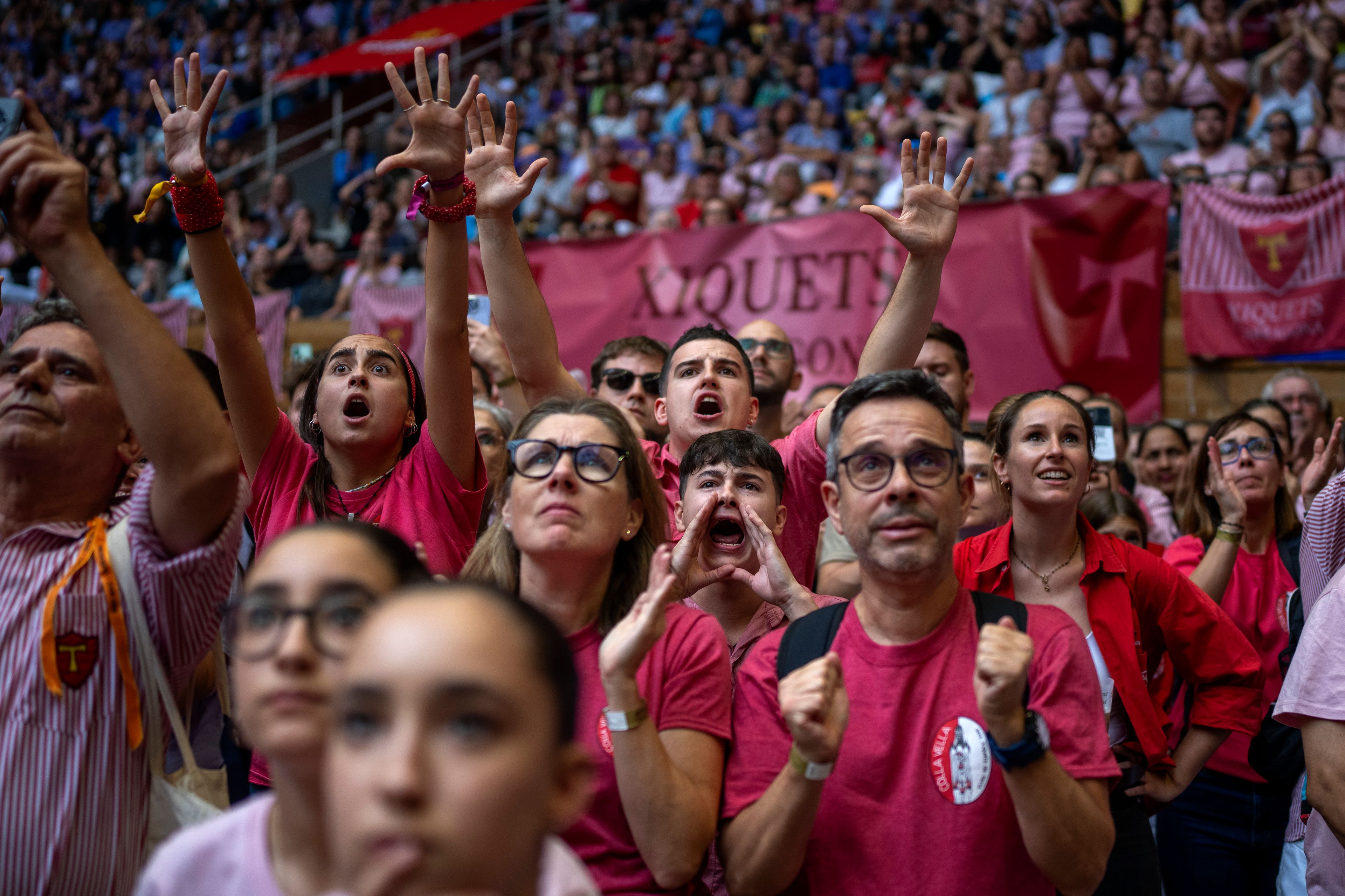 Members of "Colla Joves Xiquets de Valls" react as they form a "Castell" or human tower, during the 29th Human Tower Competition in Tarragona, Spain, Sunday, Oct. 6, 2024. (AP Photo/Emilio Morenatti)