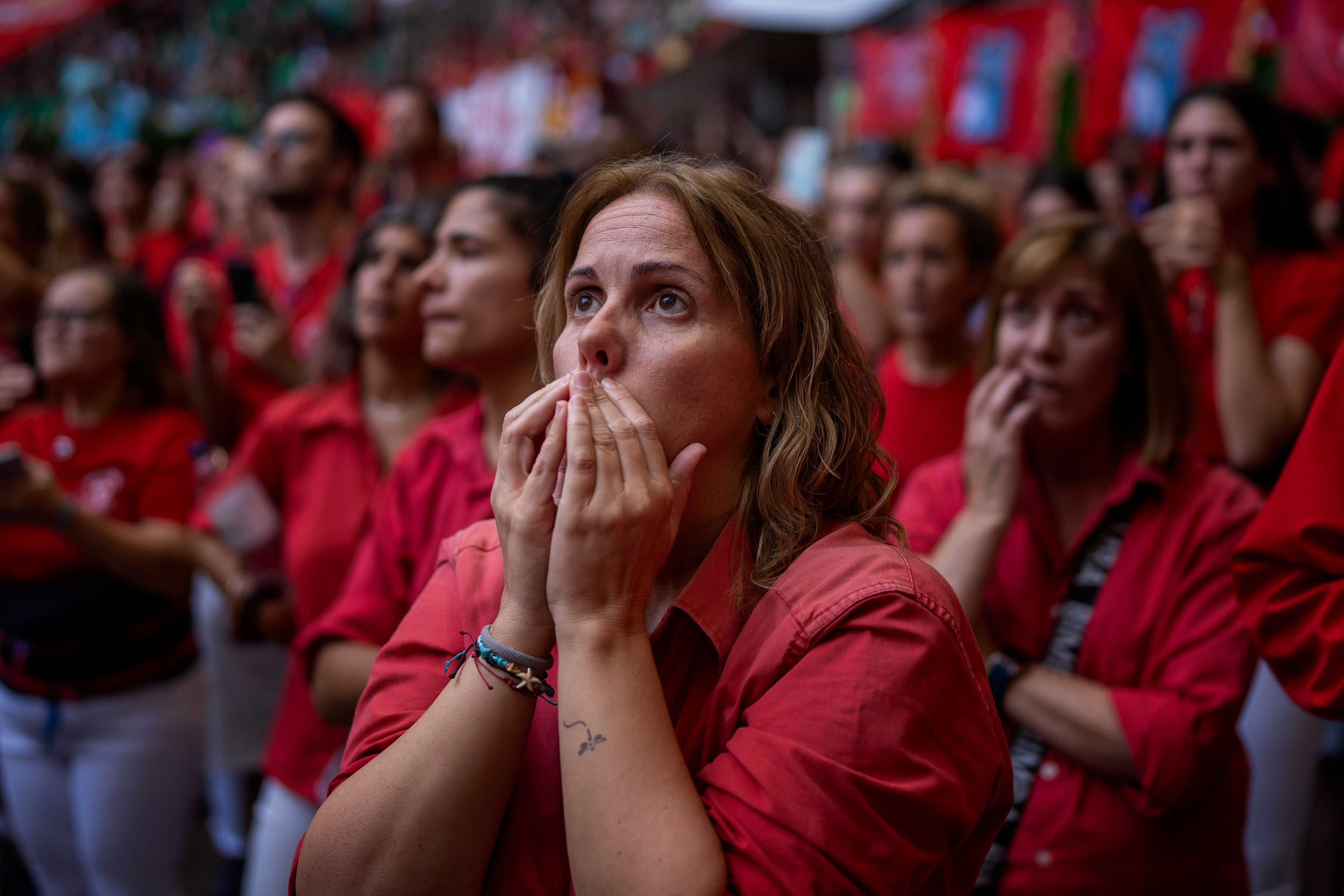 Members of "Colla Joves Xiquets de Valls" react as they form a "Castell" or human tower, during the 29th Human Tower Competition in Tarragona, Spain, Sunday, Oct. 6, 2024. (AP Photo/Emilio Morenatti)