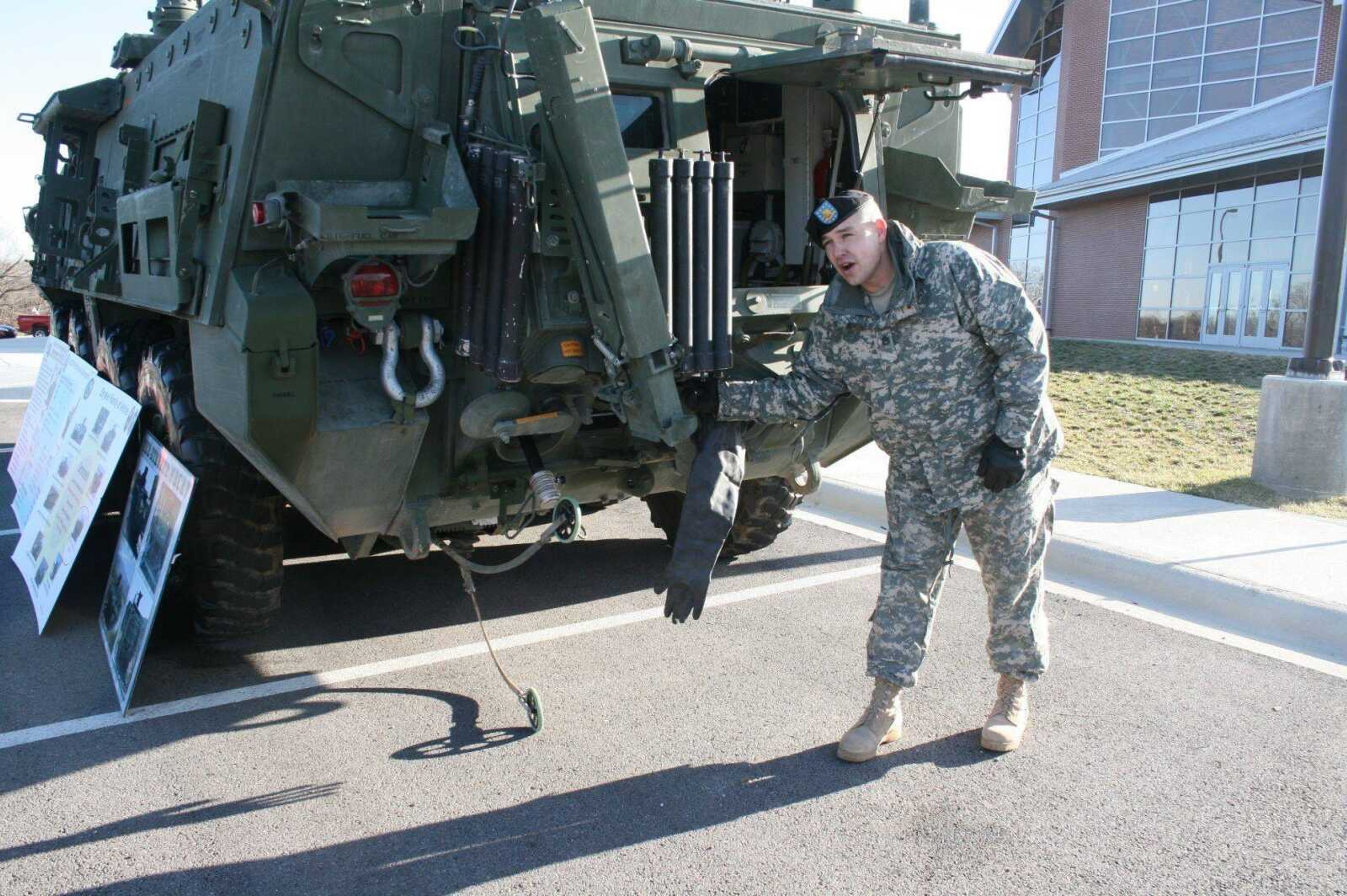 Frank Persa demonstrated how the Stryker vehicle detects chemical, biological, radiological and nuclear hazards Friday at Fort Leonard Wood. The small wheels descending from the vehicles pick up trace amounts of items to be tested for possible hazards, and the rubber glove hanging from the unit is used by soldiers to pick up solid items and put them into secure storage units for later sampling and testing. (Darrell Todd Maurina ~ Waynesville Daily Guide)