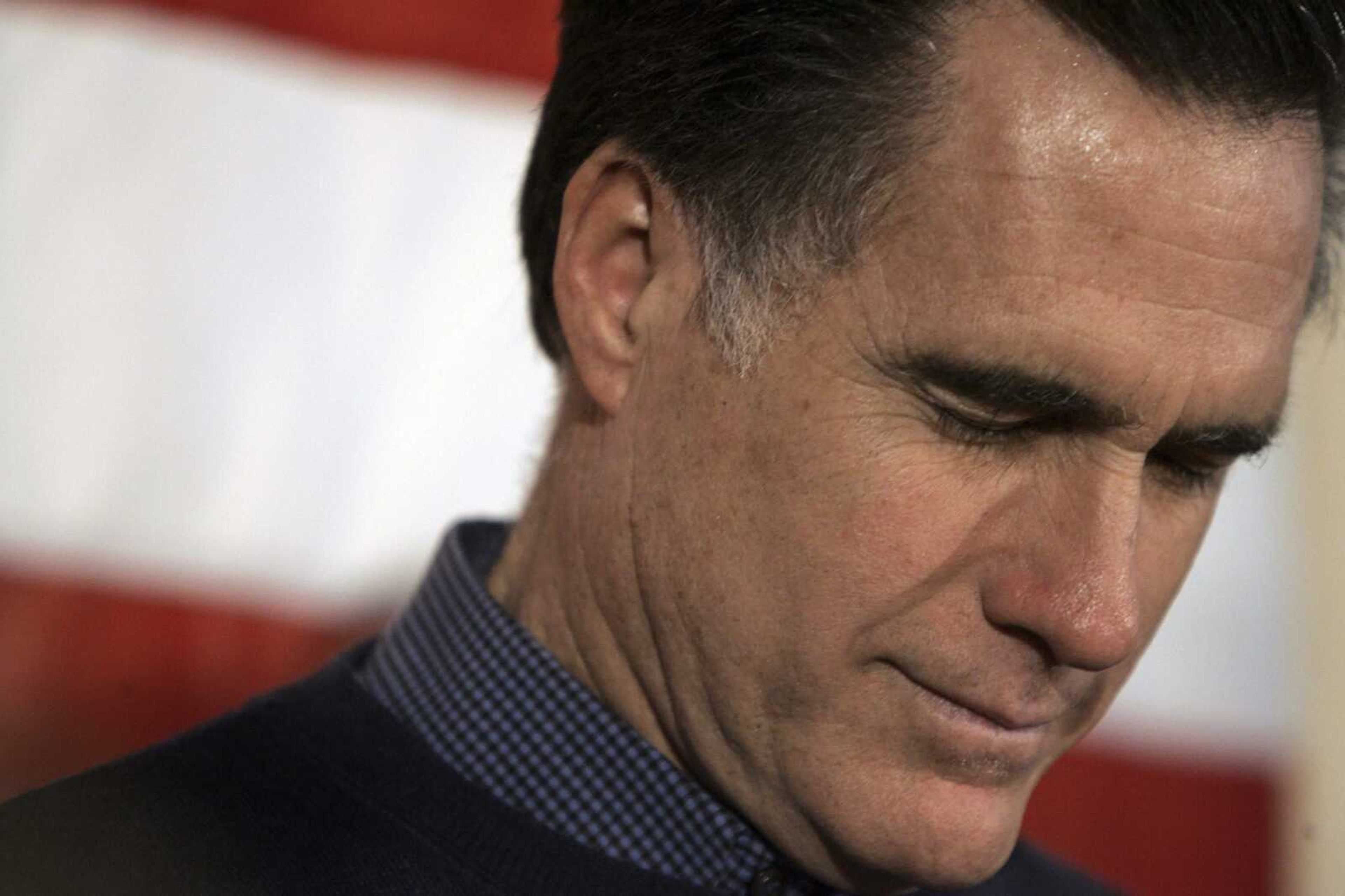 Republican presidential hopeful former Massachusetts Gov. Mitt Romney bows his head in prayer for the invocation at the Nashua Rotary Club Luncheon meeting at the Nashua Country club in Nashua, N.H., Monday, Jan. 7, 2008.  (AP Photo/LM Otero)