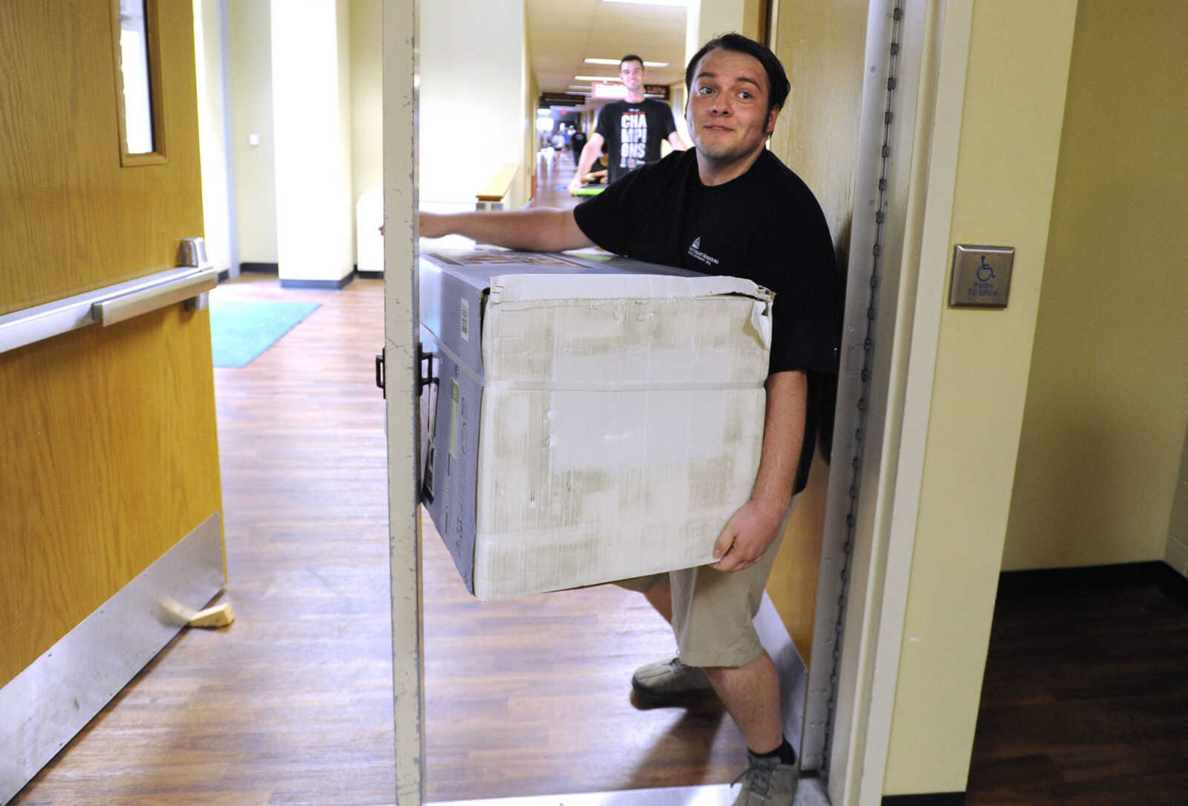 FRED LYNCH ~ flynch@semissourian.com
Tau Kappa Epsilon member Chance Ziegler takes a short break near the elevator while helping students move in Thursday, Aug. 18, 2016 at Towers South. "This is my 15th fridge today," he remarked.