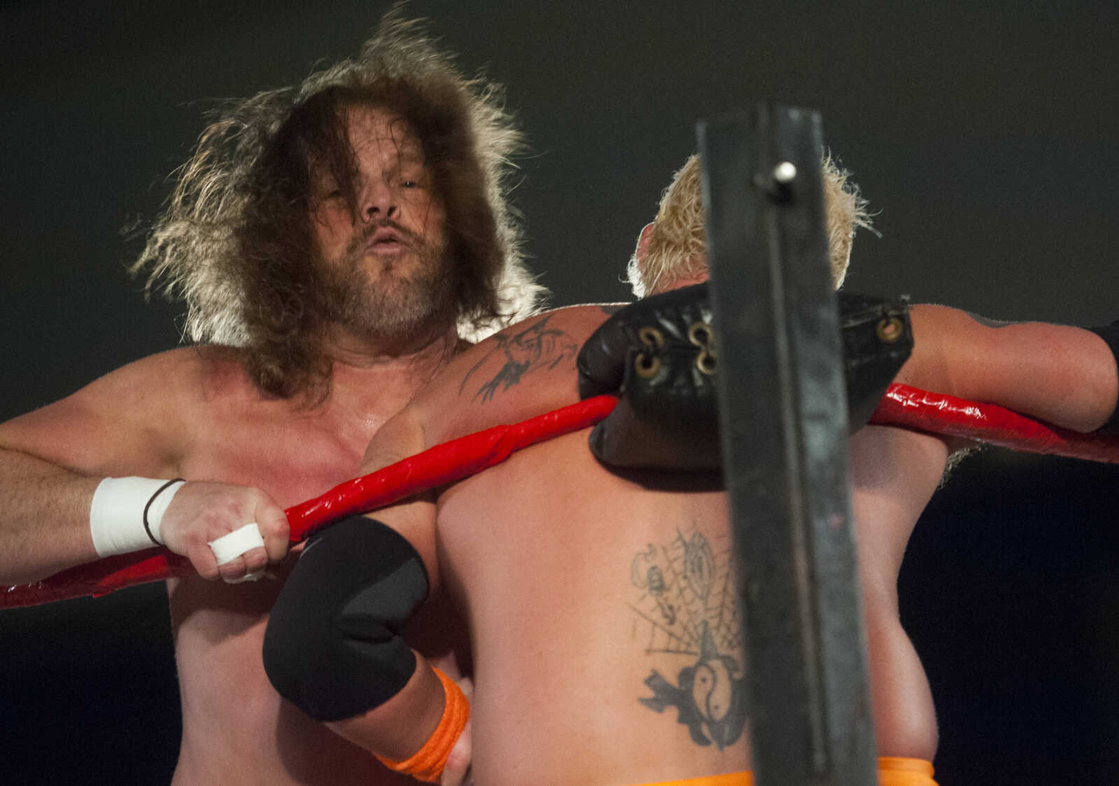 CCW wrestler Van Vanhorn, left, slams Sexy Sarge O'Riley into a turnbuckle during the "Hair vs. Hair" matchup in Cape Championship Wrestling's One Night Riot event Feb. 25, 2018, at the Arena Building in Cape Girardeau.