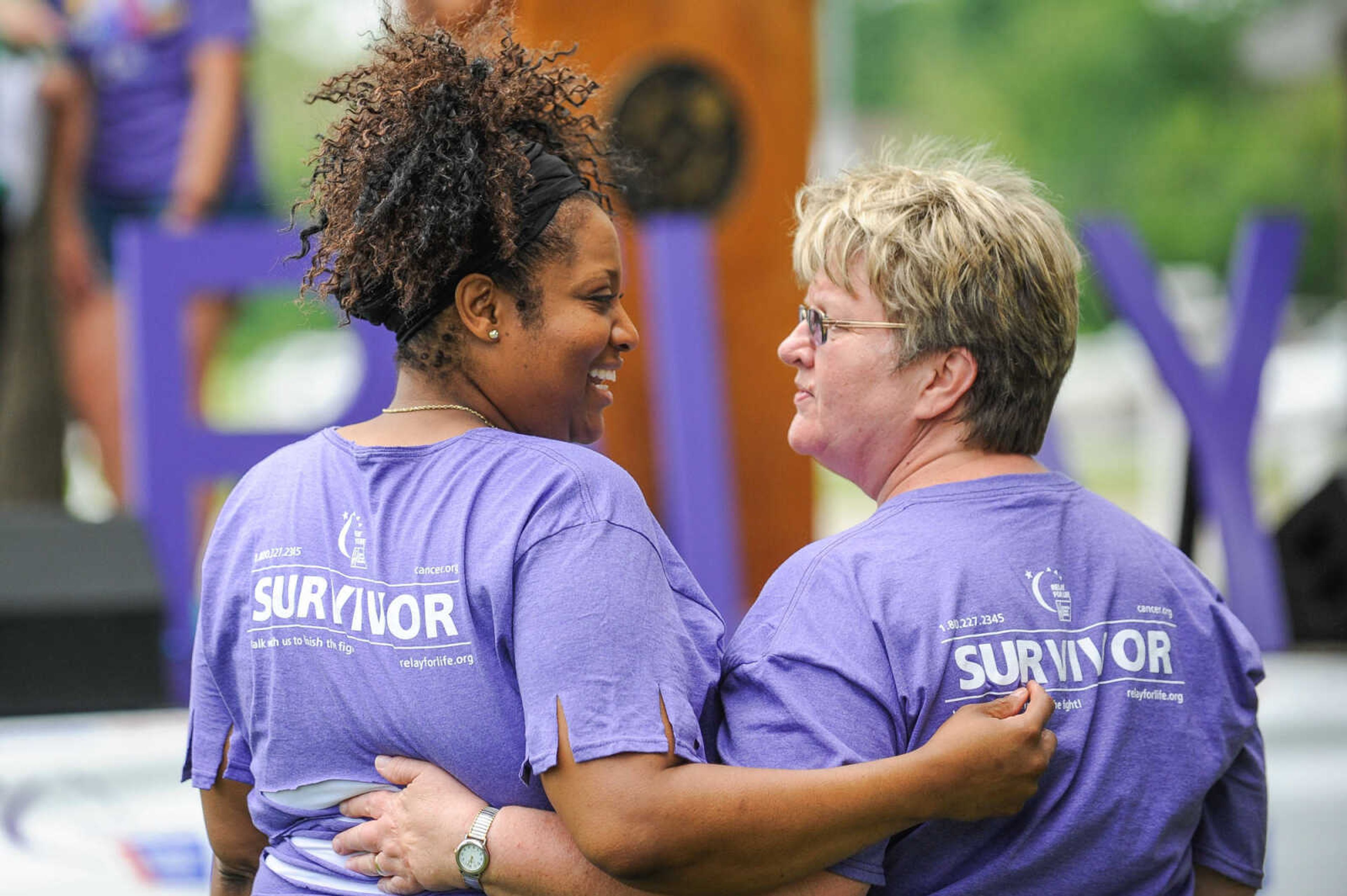 GLENN LANDBERG ~ glandberg@semissourian.com

Cancer survivors Patricia Brewer Wallace, left, and Joyce Penny greet each other during the opening ceremony of the Relay for Life of Cape Girardeau County fundraiser at Arena Park, Saturday, June 13, 2015.