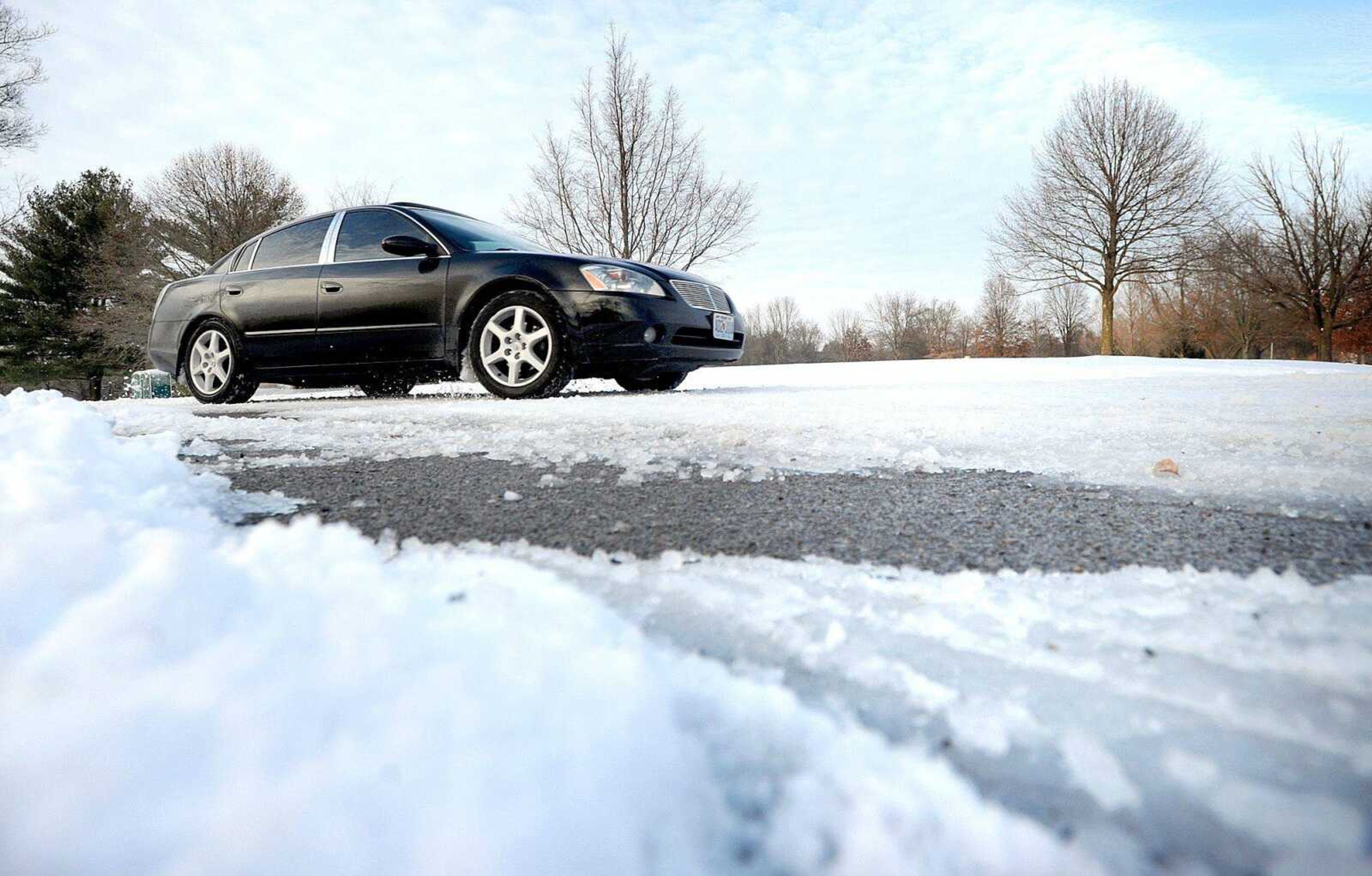 A vehicle travels through an icy patch on Rotary Drive on Monday at Kiwanis Park in Cape Girardeau. (Laura Simon)