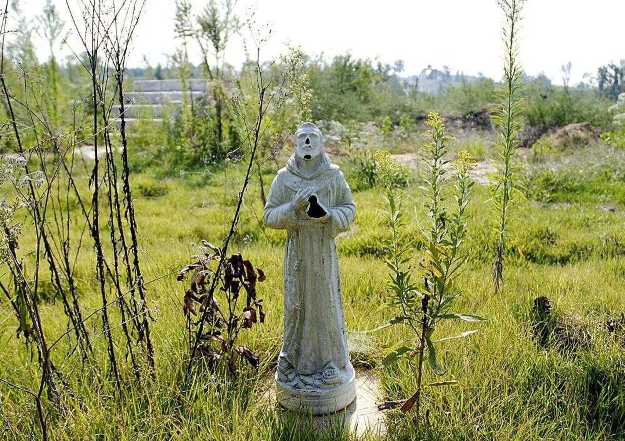 A battered statue still stands in what was once the front yard of a home on Friday in Crosstown, Mo. (AARON EISEHAUER ~ aeisenhauer@semissourian.com)