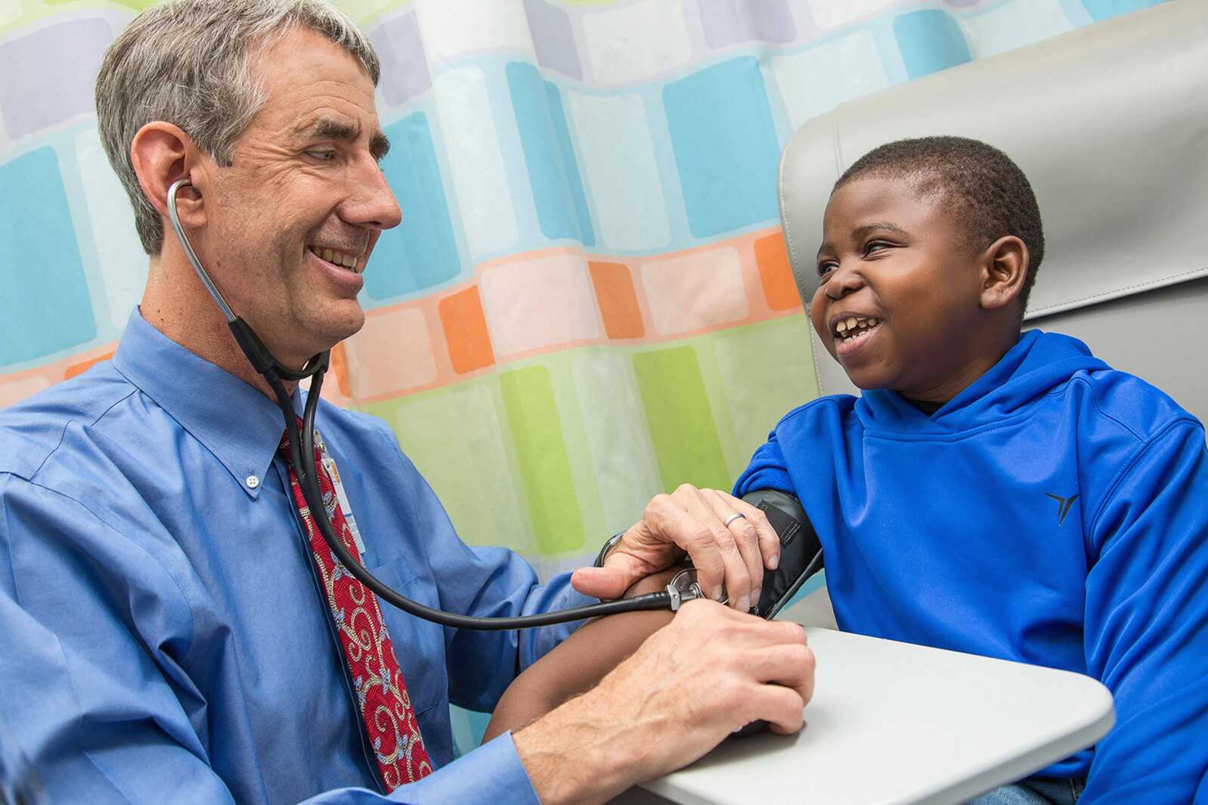 Kidney-transplant patient Marshall Jones, right, laughs with Dr. John Barcia at the University of Virginia Children's Hospital in Charlottesville. A birth defect damaged his kidneys, and a previous transplant failed when he was younger. (Coe Sweet ~ UVA Health System via AP)