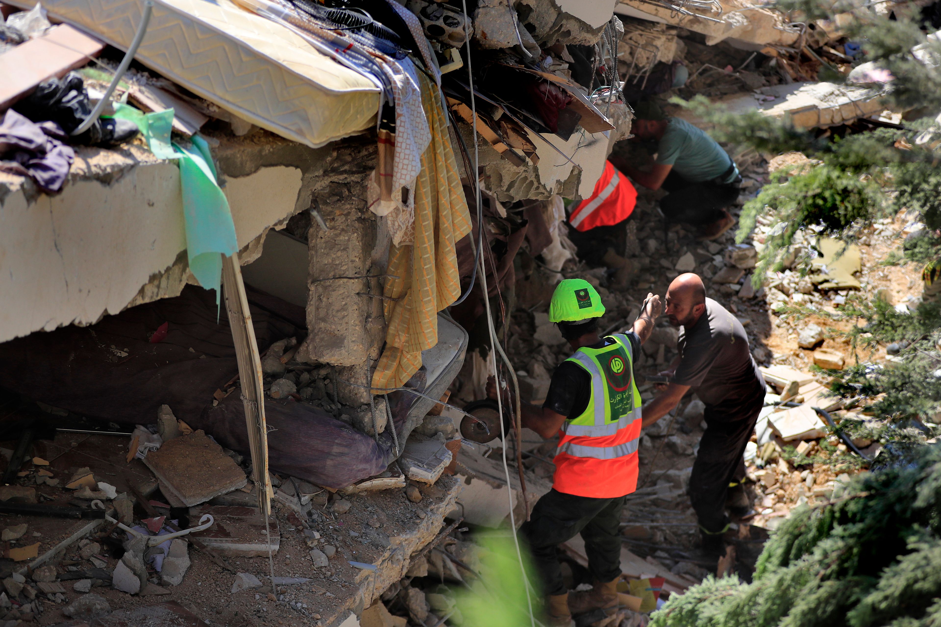 Rescuers look for survivors under the rubble of a destroyed building that was hit on Sept. 29 during the deadliest Israeli airstrike on the first week of escalation between Israel and Hezbollah where more than 70 people were killed, in Ain el Delb neighbourhood outside the Lebanese coastal city of Sidon, Monday, Sept. 30, 2024.(AP Photo/Mohammed Zaatari)