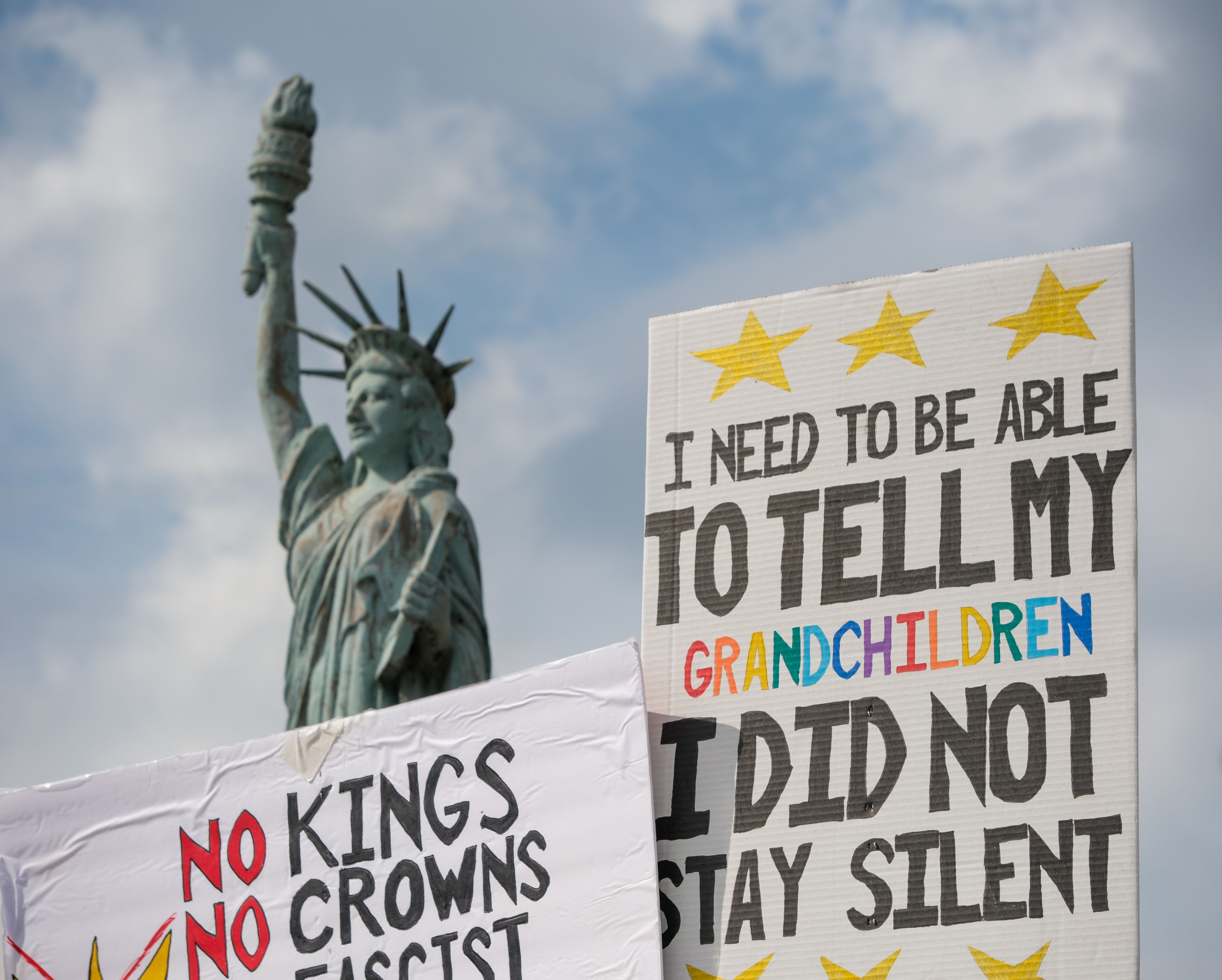 An estimated 400 people filled the intersection at Freedom Corner in Cape Girardeau on Saturday, Oct. 18, 2025, as participants waved signs and flags to passing traffic in Cape Girardeau.