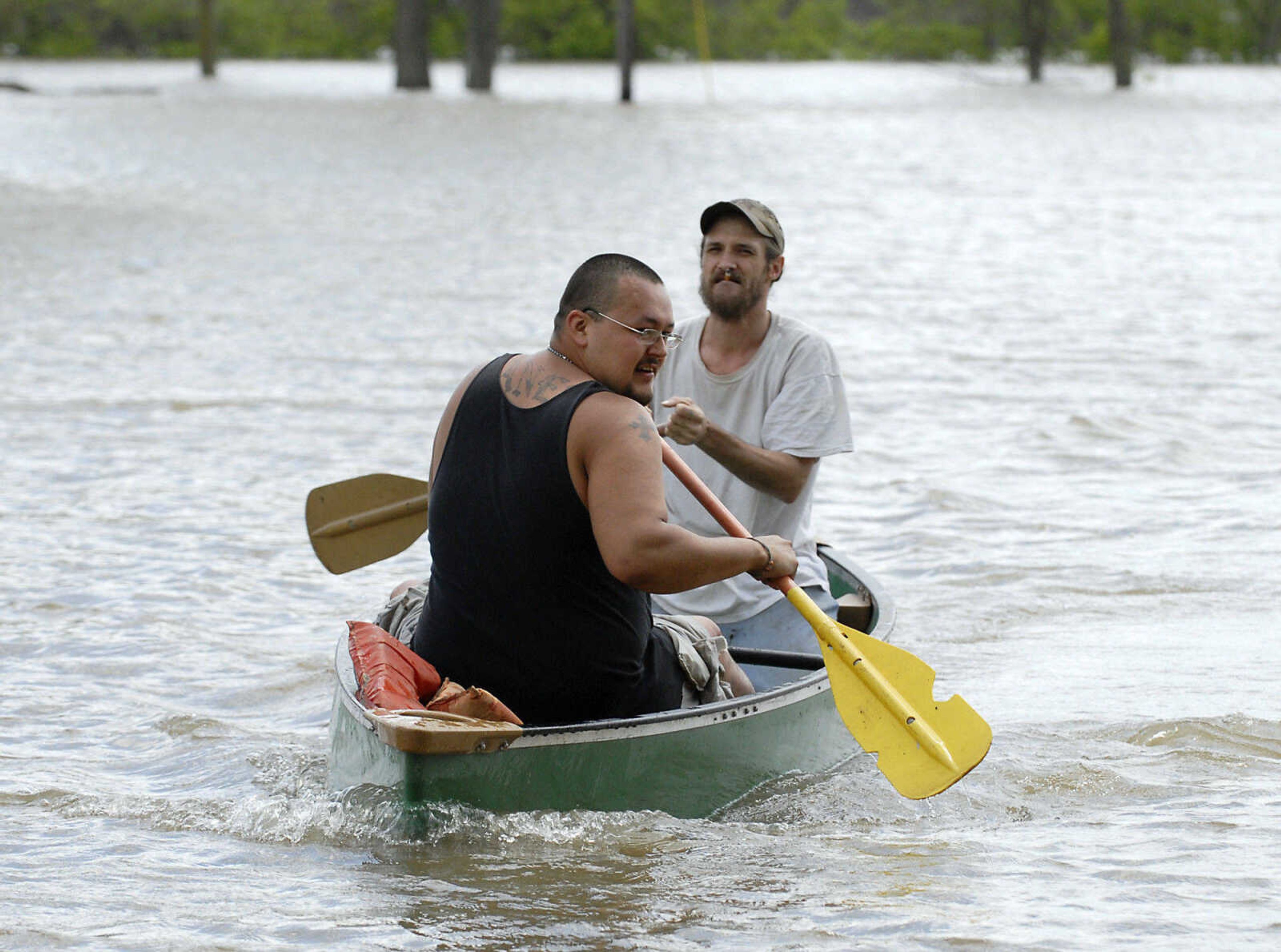 KRISTIN EBERTS ~ keberts@semissourian.com

Gabriel Yanes, left, and Joshua Robertson, right, use a canoe to paddle up North Main Street toward the home of Bill Sandquist on Thursday, April 28, 2011, in Cape Girardeau, Mo.