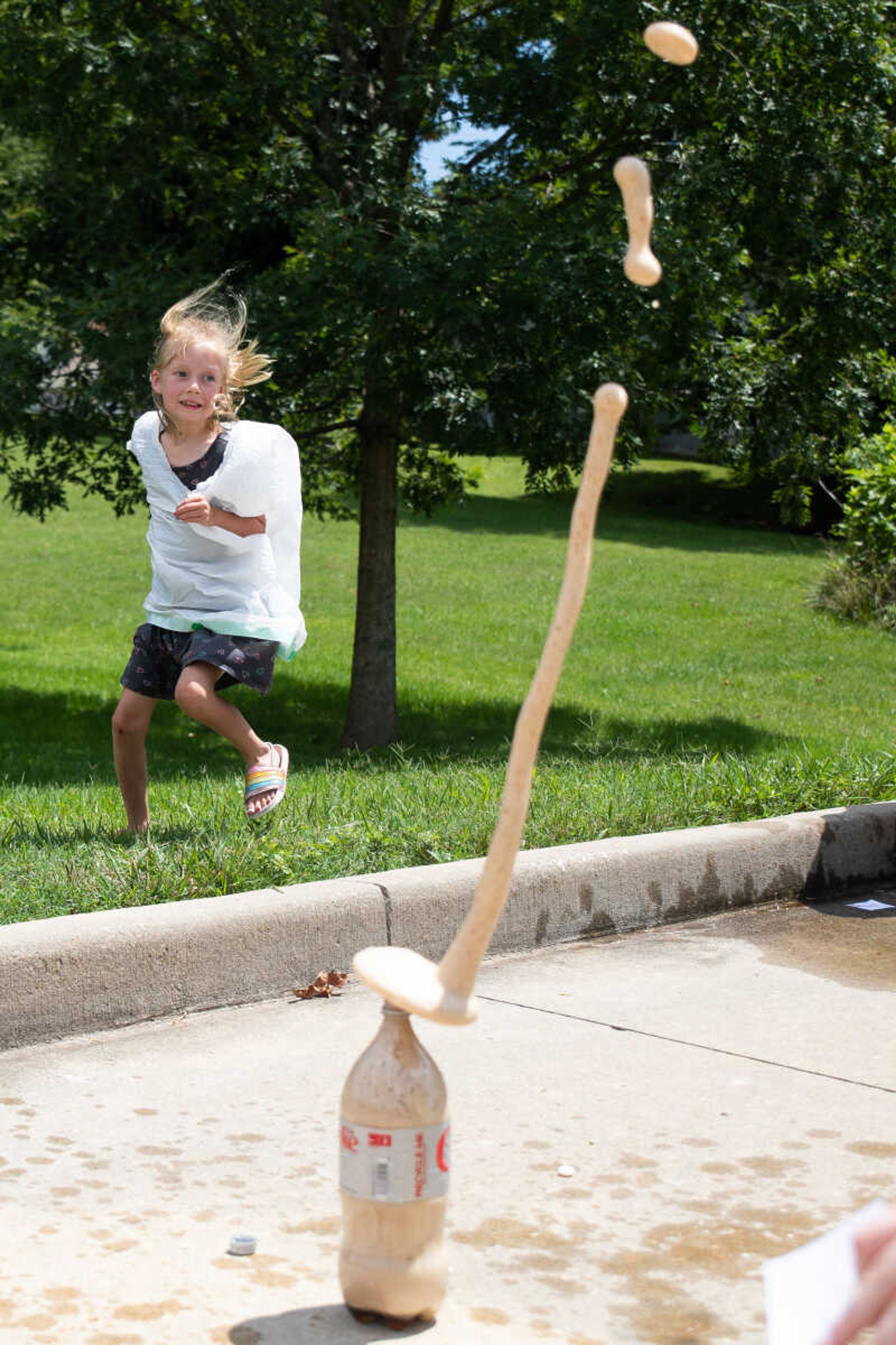 Avery Heuring reacts as a Coke bottle erupts.