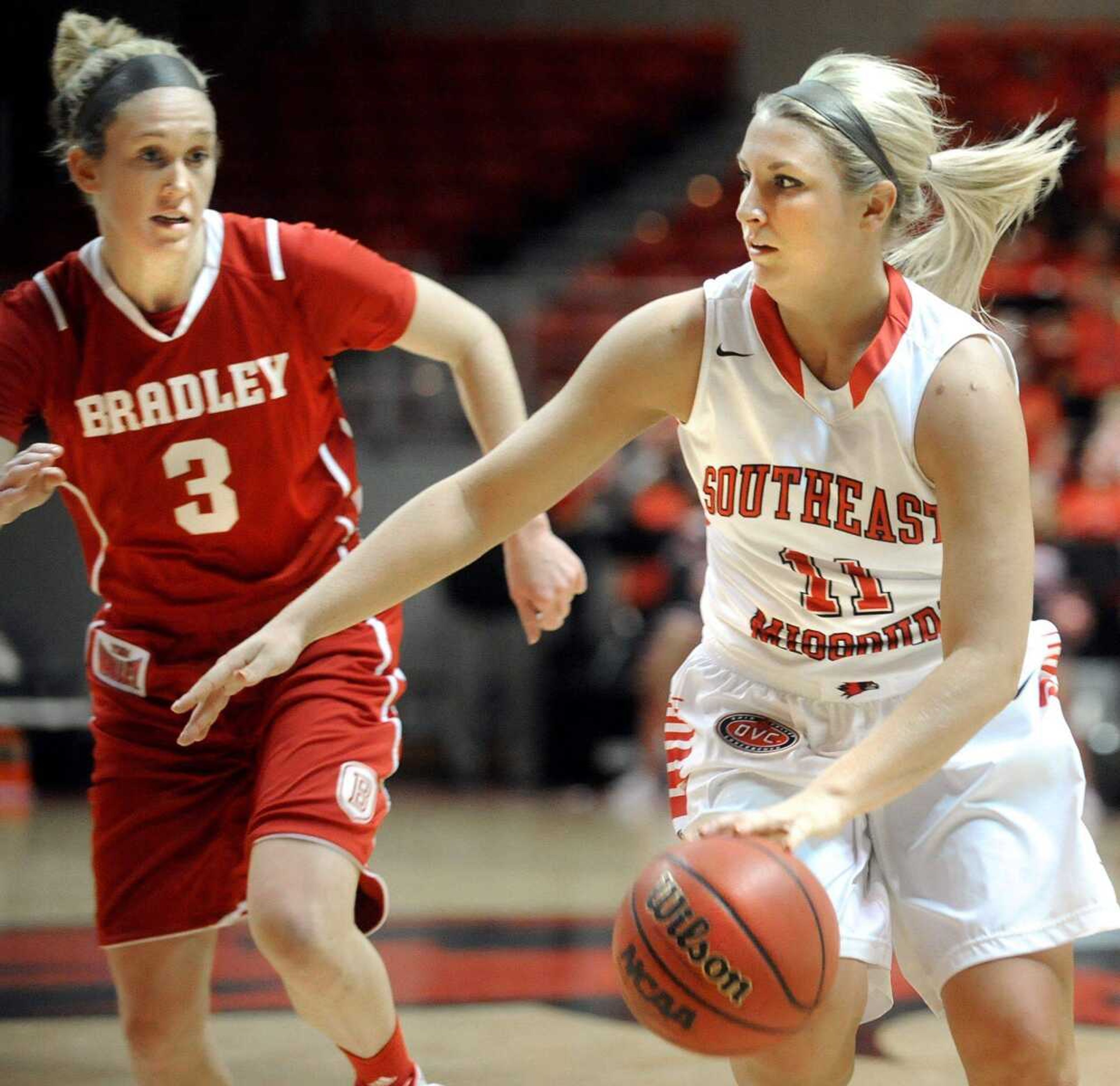 Southeast Missouri State's Allyson Bradshaw drives the ball past Bradley defender Kelsey Budd in the second half, Monday, Nov. 11, 2013, at the Show Me Center. (Laura Simon)