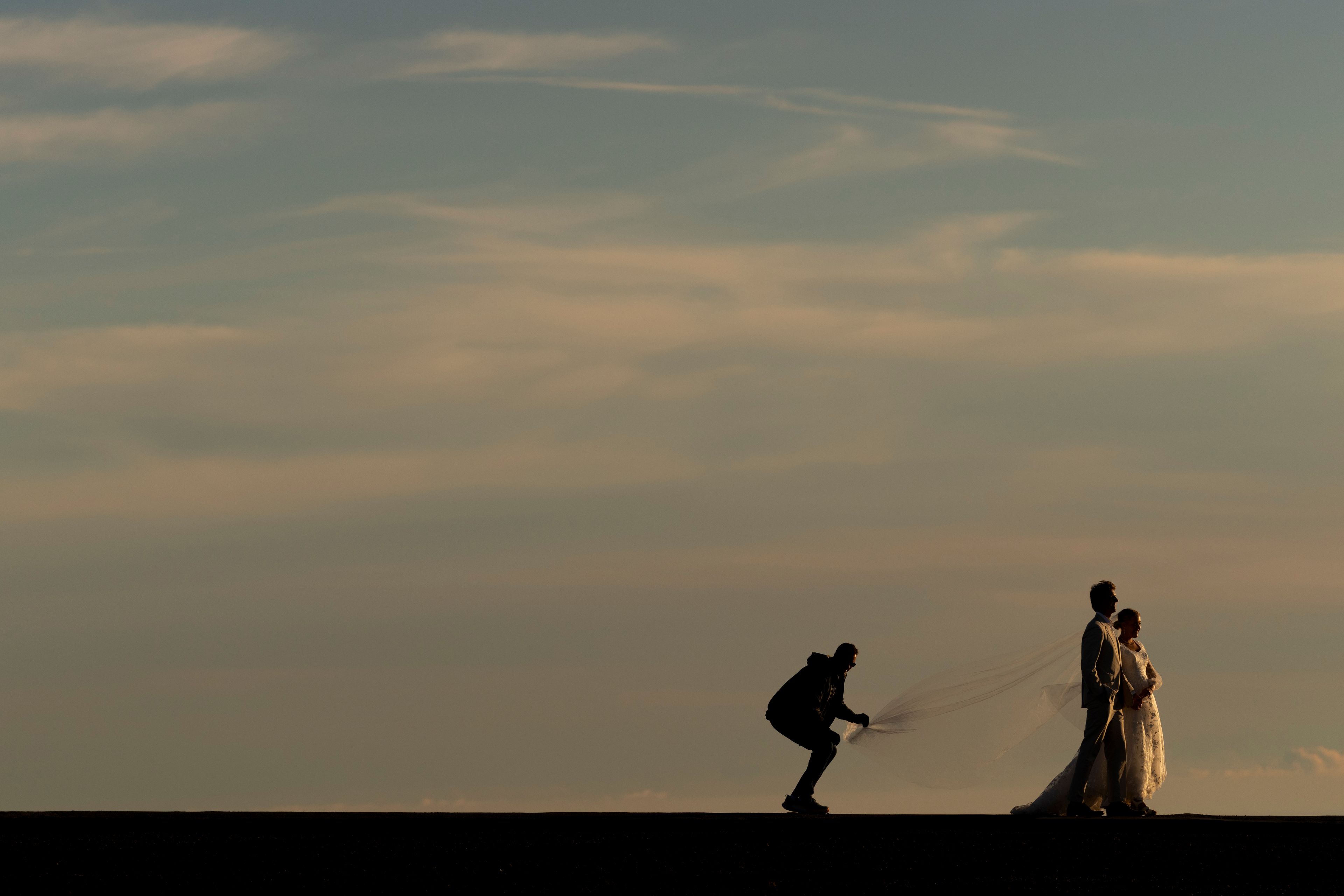 A couple takes photos at the summit of Haleakala National Park, Saturday, Nov. 23, 2024, near Kula, Hawaii. (AP Photo/Lindsey Wasson)