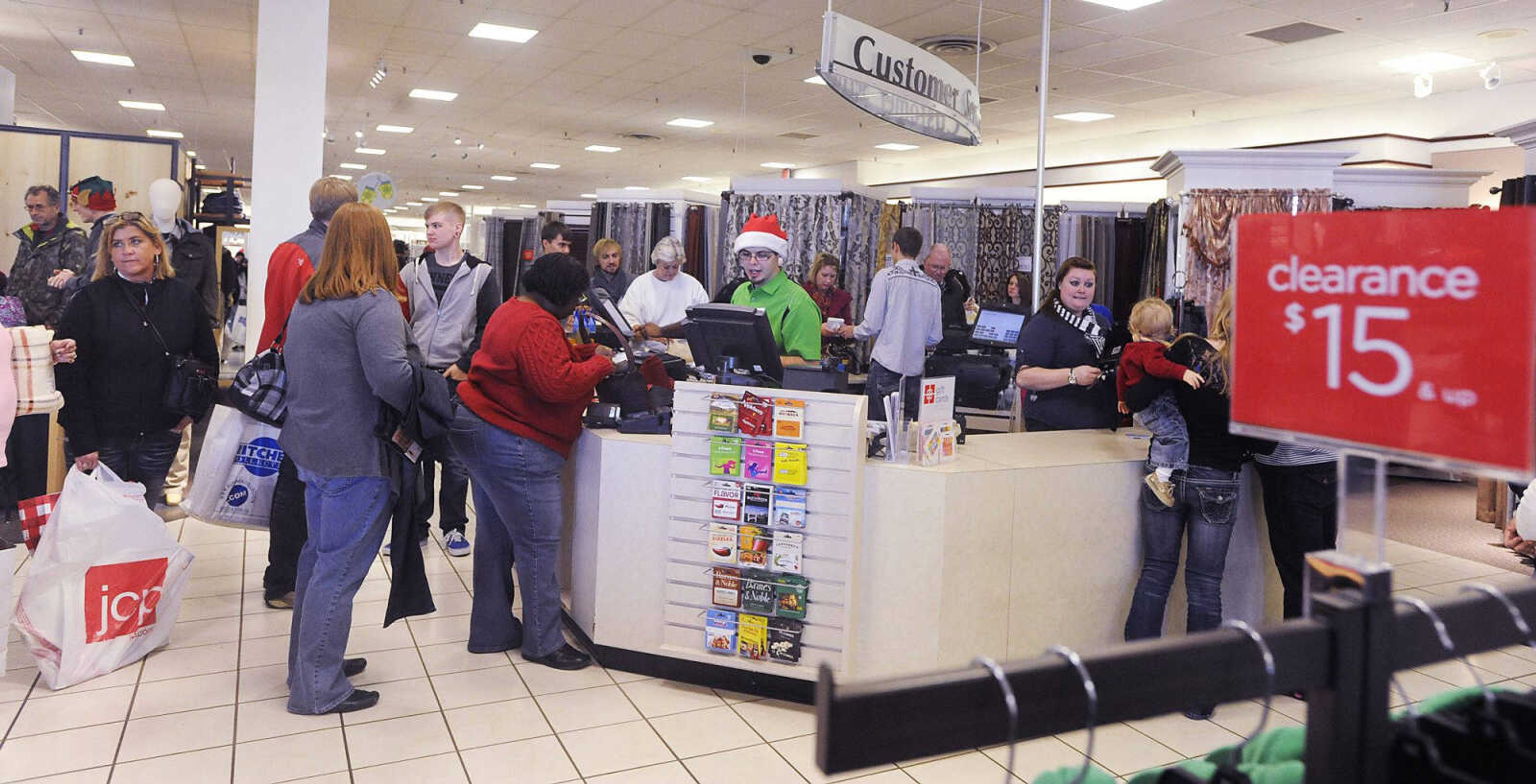 Shoppers wait in line to check out at JC Penny in West Park Mall on Saturday in Cape Girardeau. "Super Saturday," the Saturday before Christmas, is often the second busiest shopping day of the year, behind Black Friday. (Adam Vogler)