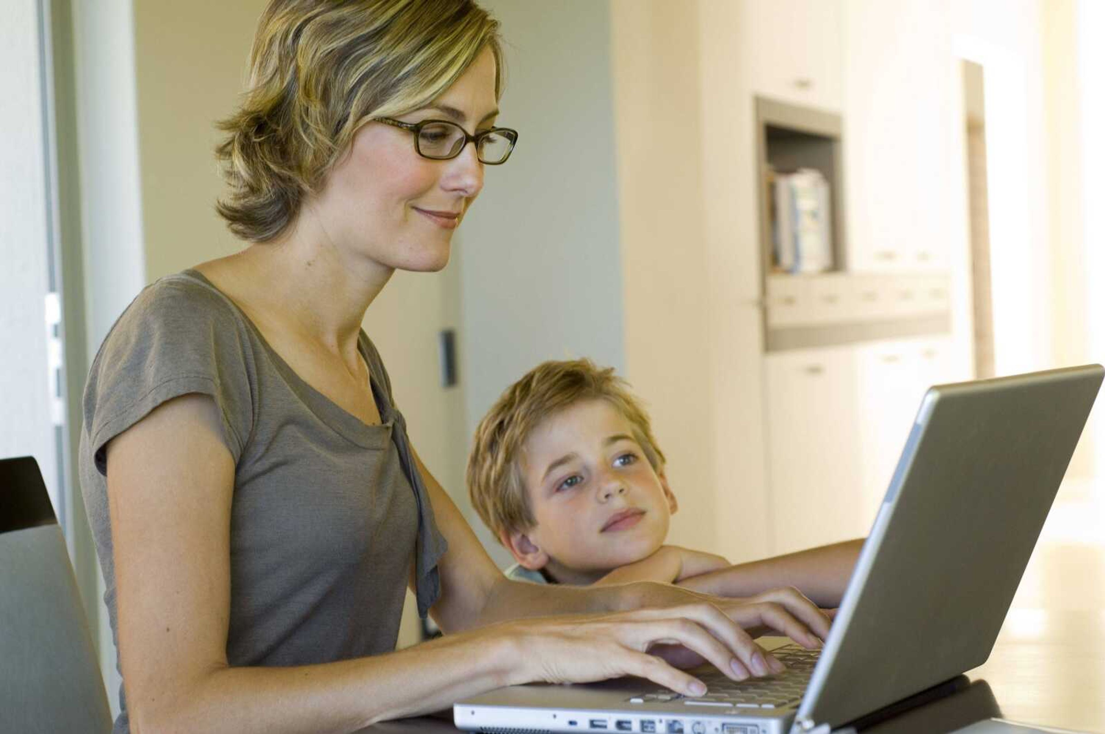 Woman and boy using laptop computer