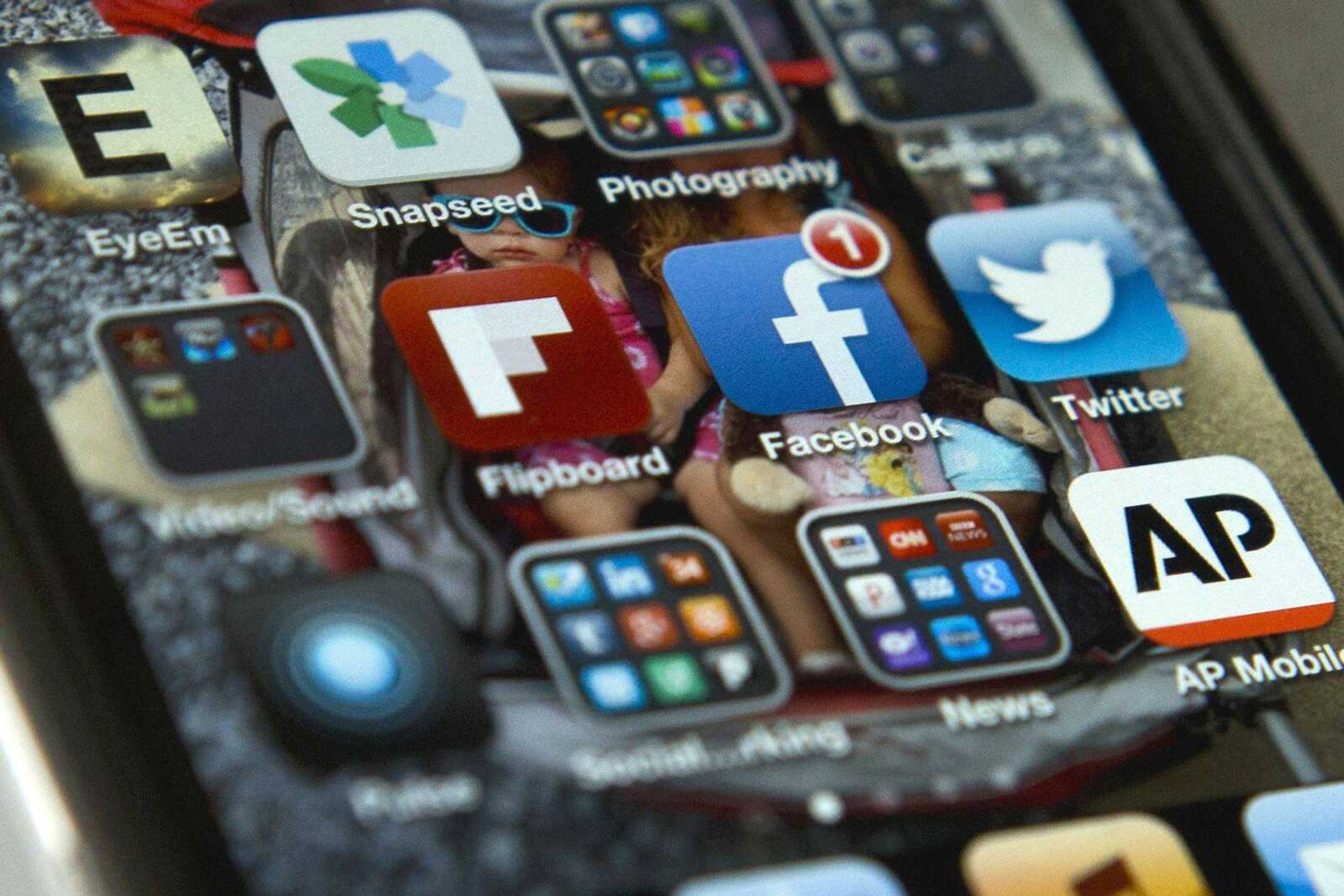 A view of an iPhone Tuesday in Washington shows the Twitter and Facebook apps among others. (Evan Vucci ~ Associated Press)