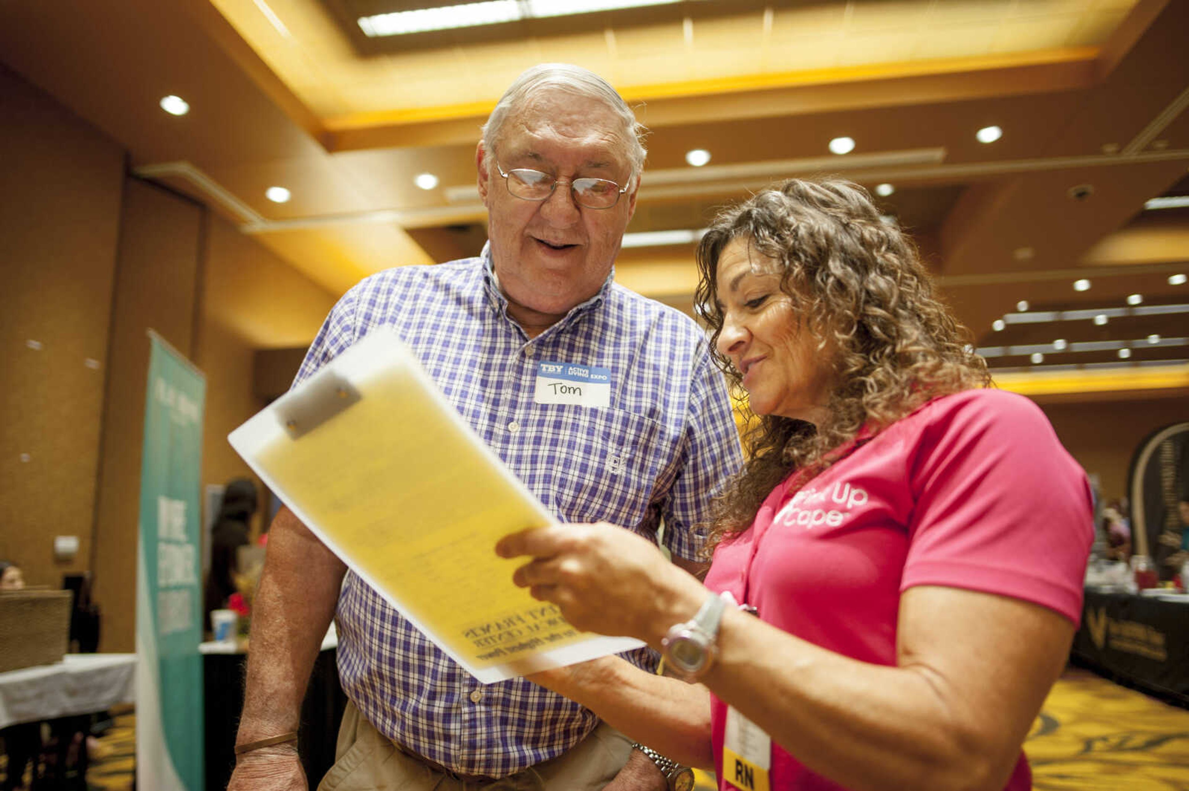 Tom Wright, left, discusses the results of a health screening with Saint Francis Medical Center representative Eileen Sievers during the TBY Active Living Expo Wednesday, Oct. 9, 2019, at the Isle Casino in Cape Girardeau.