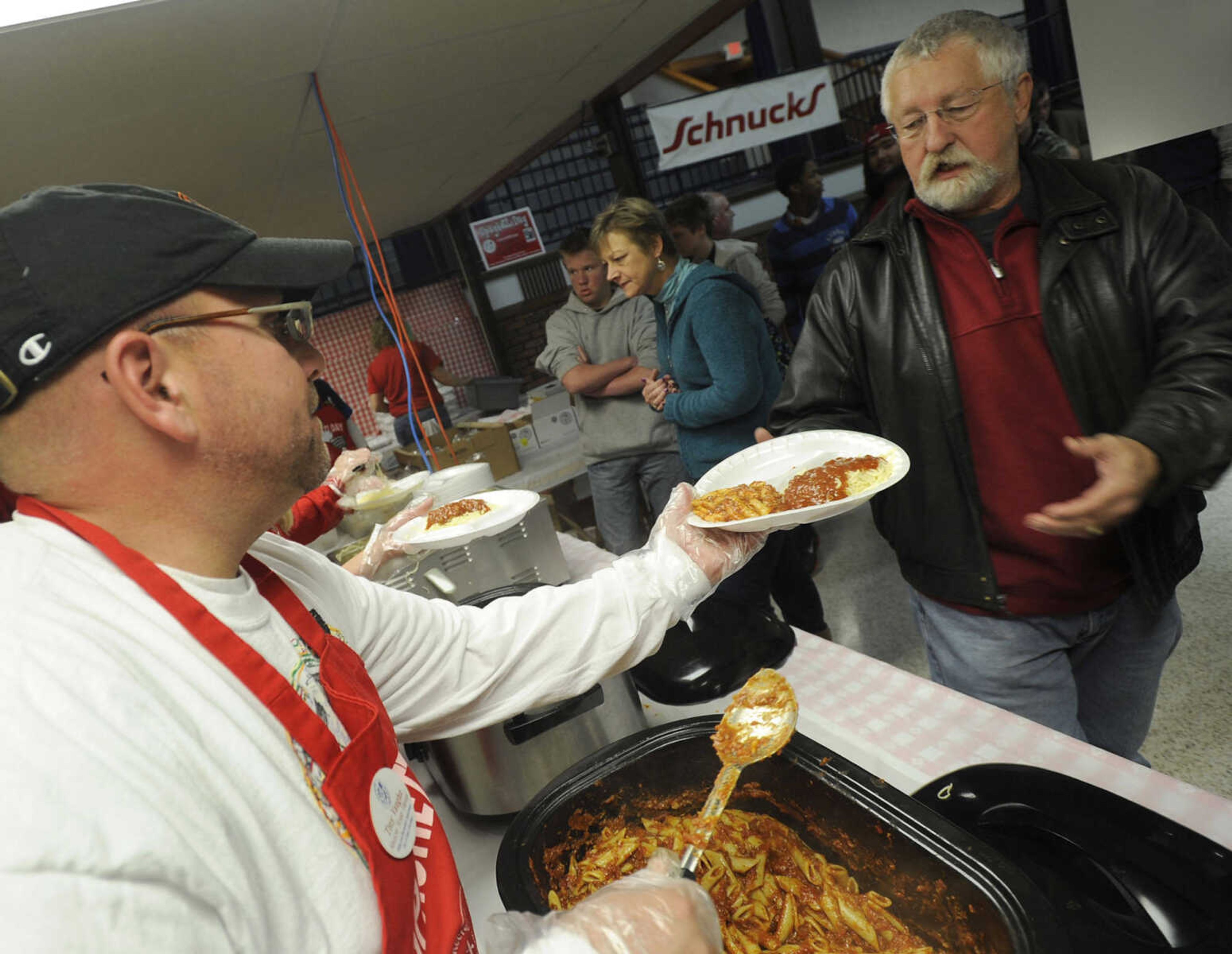 FRED LYNCH ~ flynch@semissourian.com
Troy Vaughn serves mostaccioli to Steve Stilson at the Parks & Recreation Foundation Spaghetti Day Wednesday, Nov. 13, 2013 at the Arena Building.