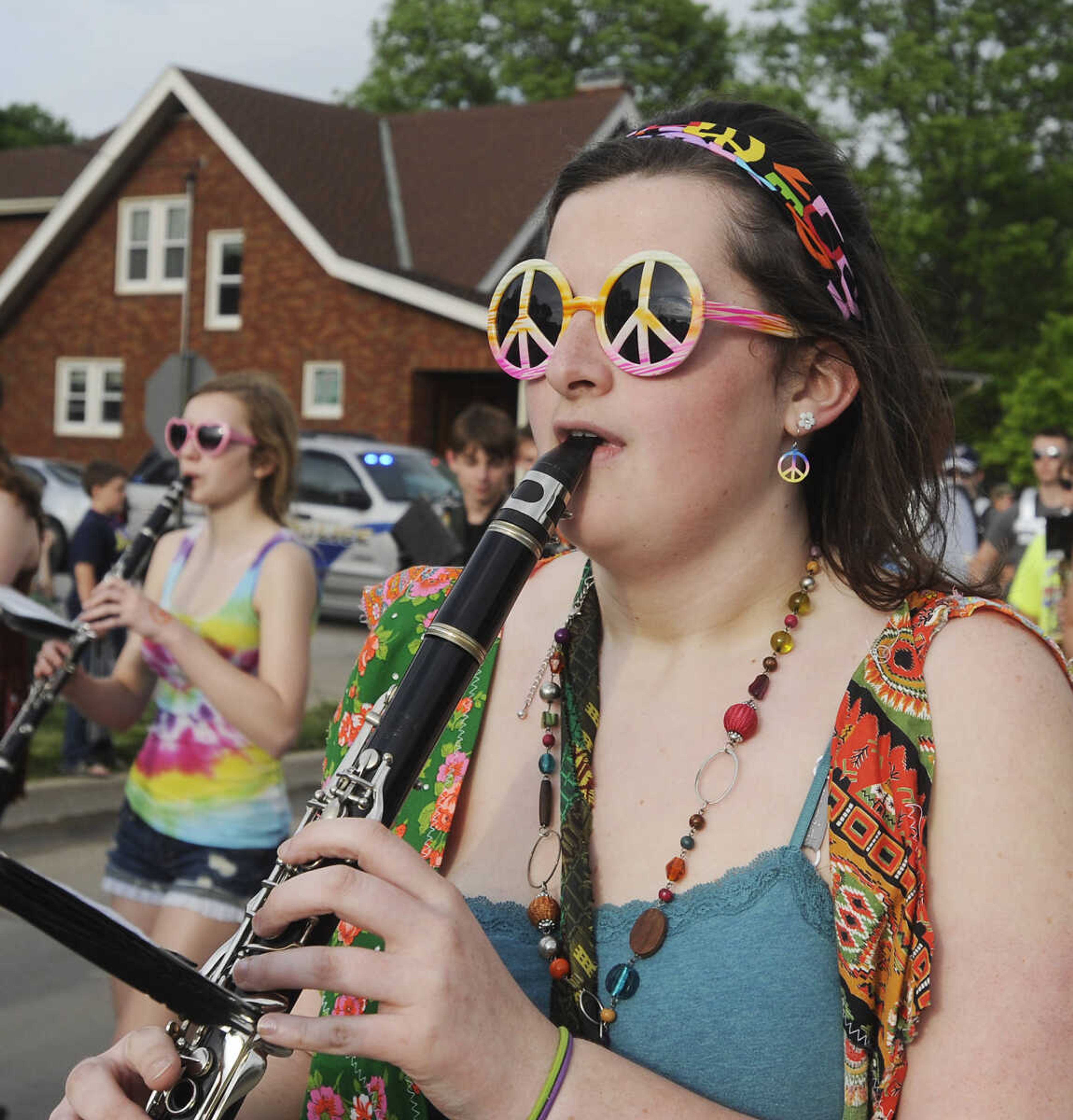 Michaela Kohn, 18, performs with the Perryville High School Marching Band during the Perryville Mayfest Parade Friday, May 10, in Perryville, Mo. This year's Mayfest theme is Peace, Love, Perryville Mayfest.