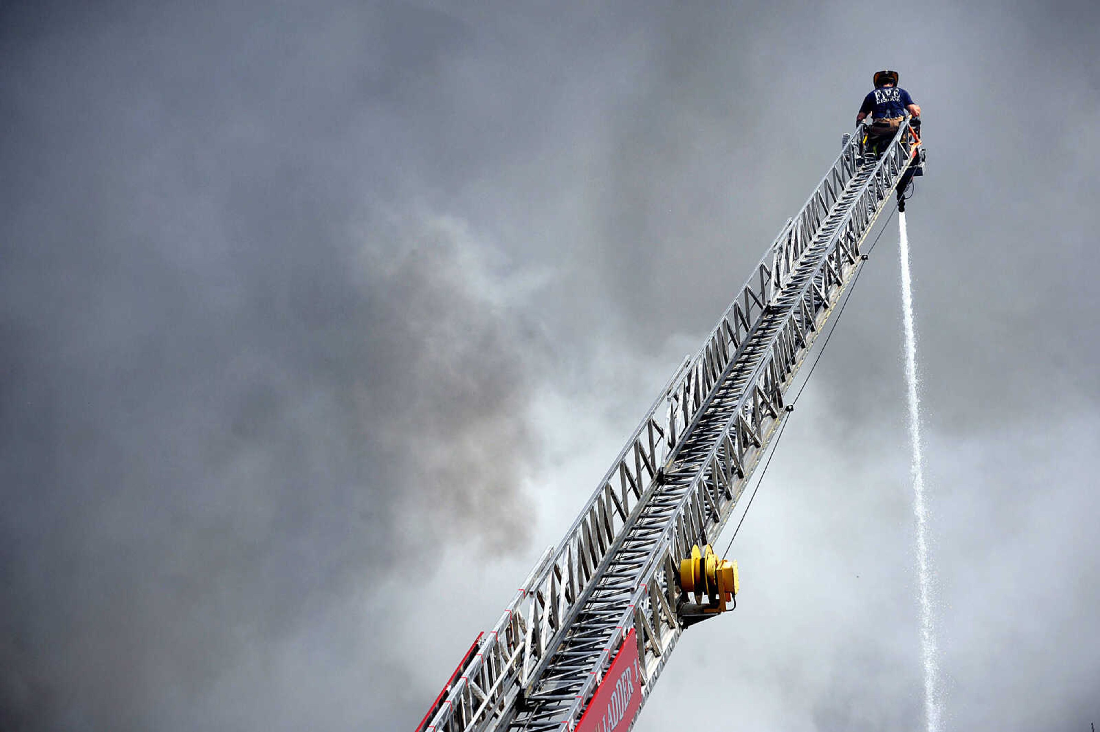 LAURA SIMON ~ lsimon@semissourian.com

Dark smoke billows through the air as Jamie Hann with the Cape Girardeau Fire Department showers the smoldering remnants of the Missouri Plastics plant Friday morning, Oct. 4, 2013, in Jackson. The approximately 100,00-square-foot recycling plant caught fire around 10 p.m. Thursday. Every fire department in Cape Girardeau County was dispatched to battle the blaze.