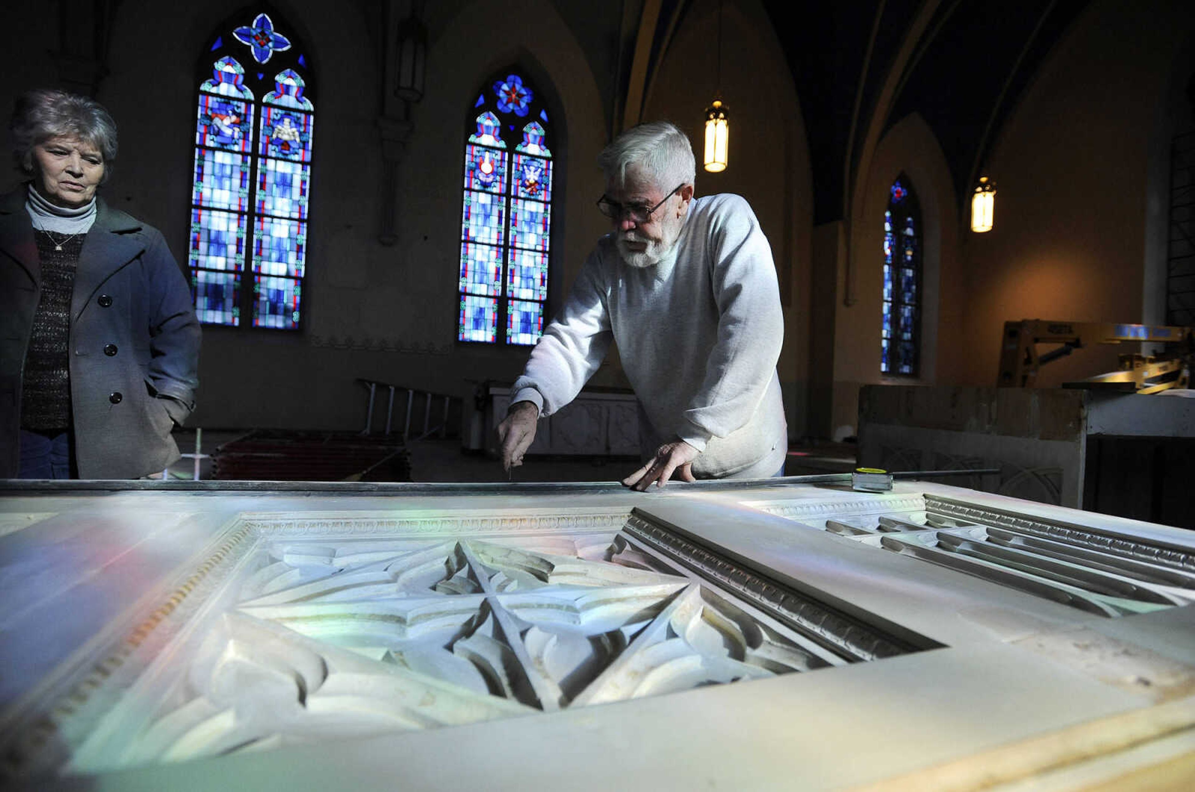 LAURA SIMON ~ lsimon@semissourian.com

Sharon Hopkins watches as Nick Elfrink measures the length of an altar inside St. John's Catholic Church in Leopold, Missouri on Feb. 11, 2016. Elfrink and his wife Geri repaired and painted the altars inside the church. .