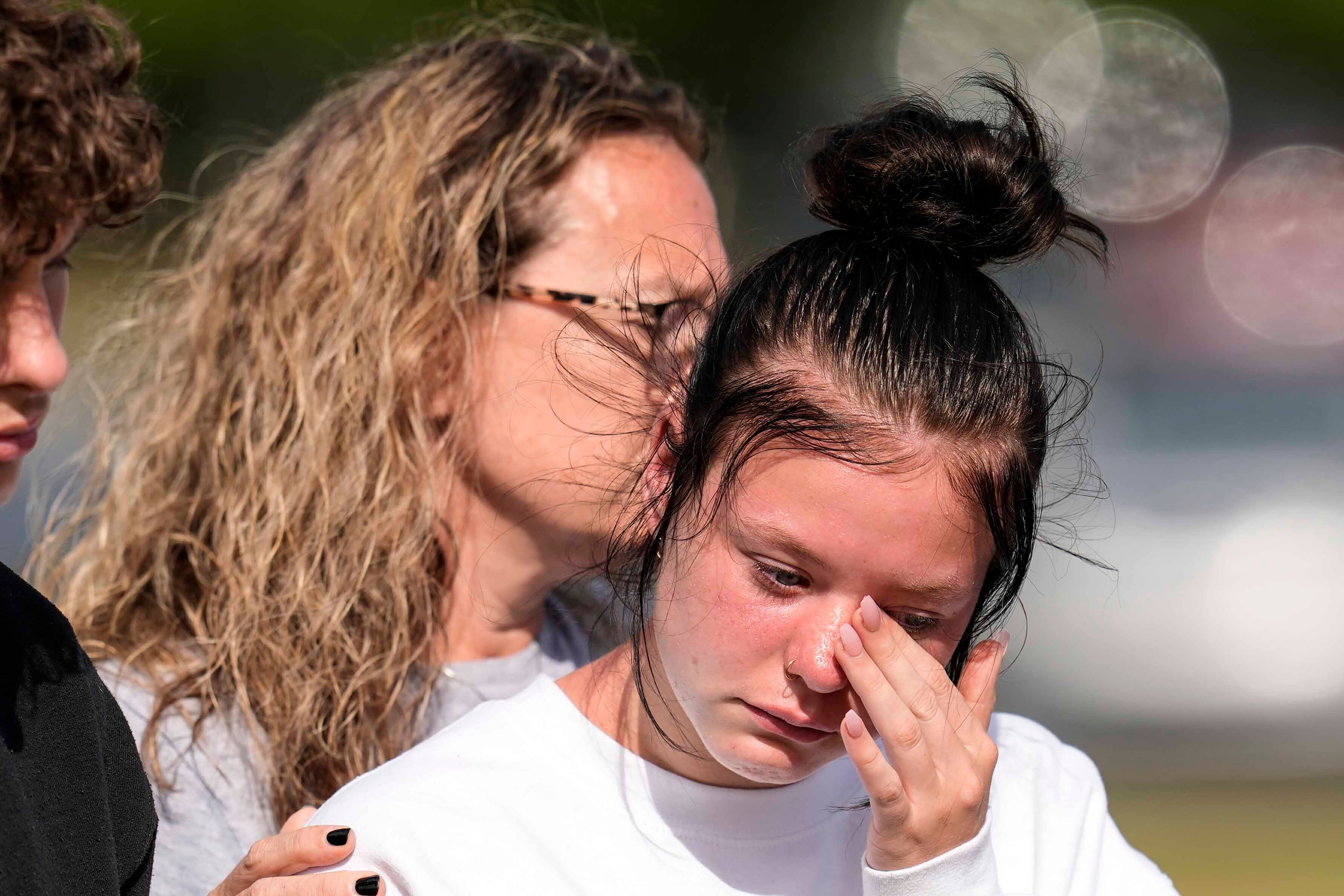 A student weeps at a makeshift memorial after a shooting Wednesday at Apalachee High School, Thursday, Sept. 5, 2024, in Winder, Ga. (AP Photo/Mike Stewart)