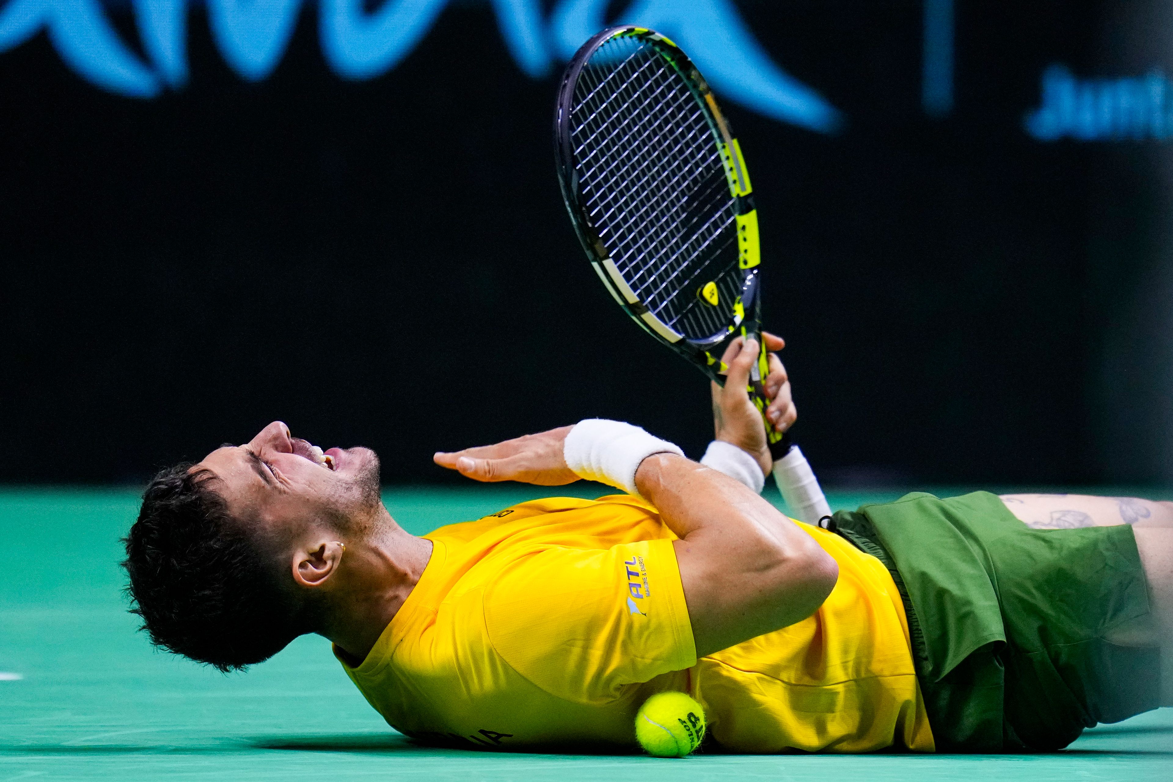 Australia's Athanasios Kokkinakis celebrates after winning against Ben Shelton of the United States during a Davis Cup quarterfinal match at the Martin Carpena Sports Hall, in Malaga, southern Spain, on Thursday, Nov. 21, 2024. (AP Photo/Manu Fernandez)