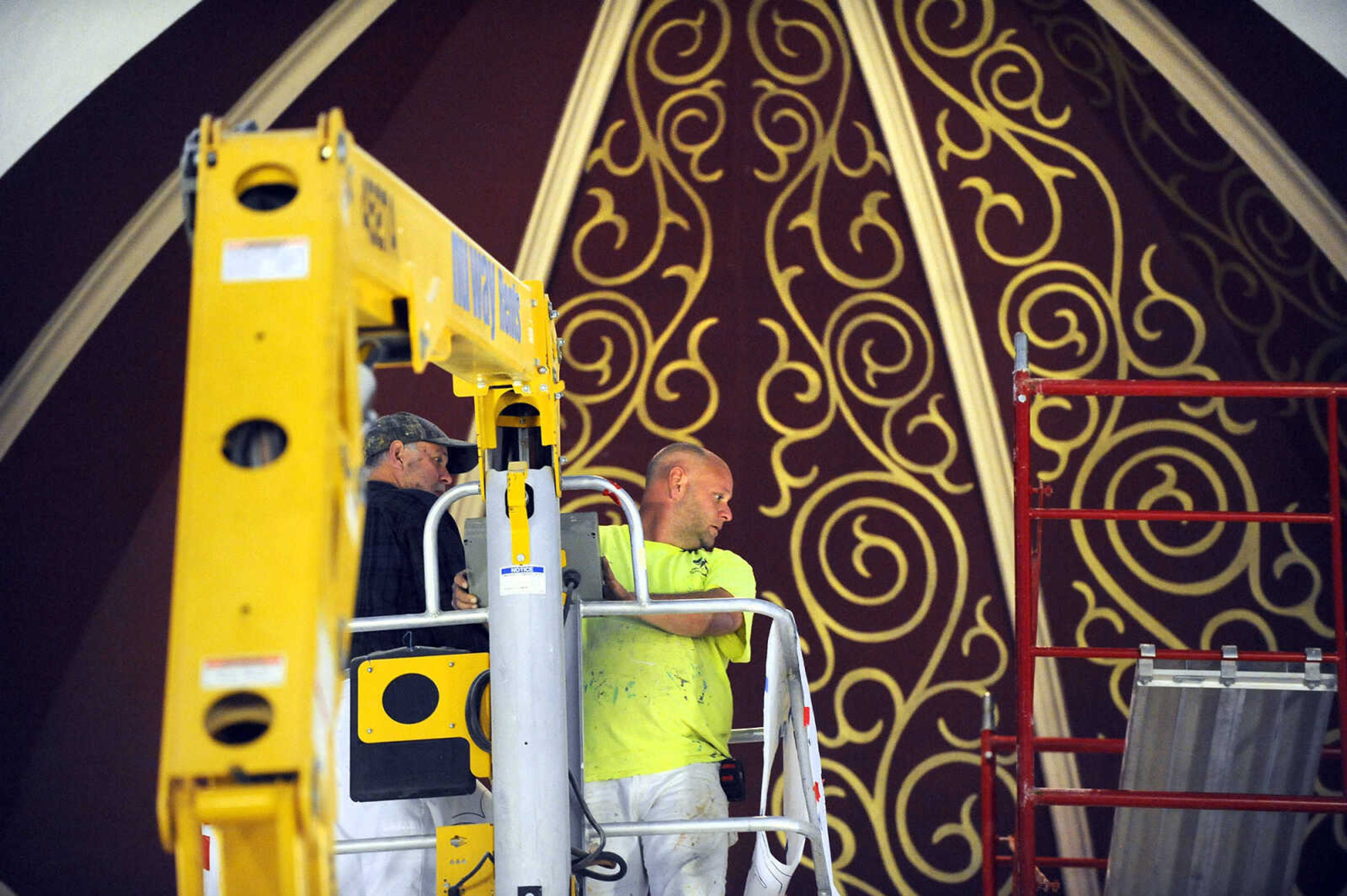 LAURA SIMON ~ lsimon@semissourian.com

Gary West, left, and Roy Diamond make their way to the ceiling above the altar in a cherry picker to work on the stenciling at St. John's Catholic Church in Leopold, Missouri.