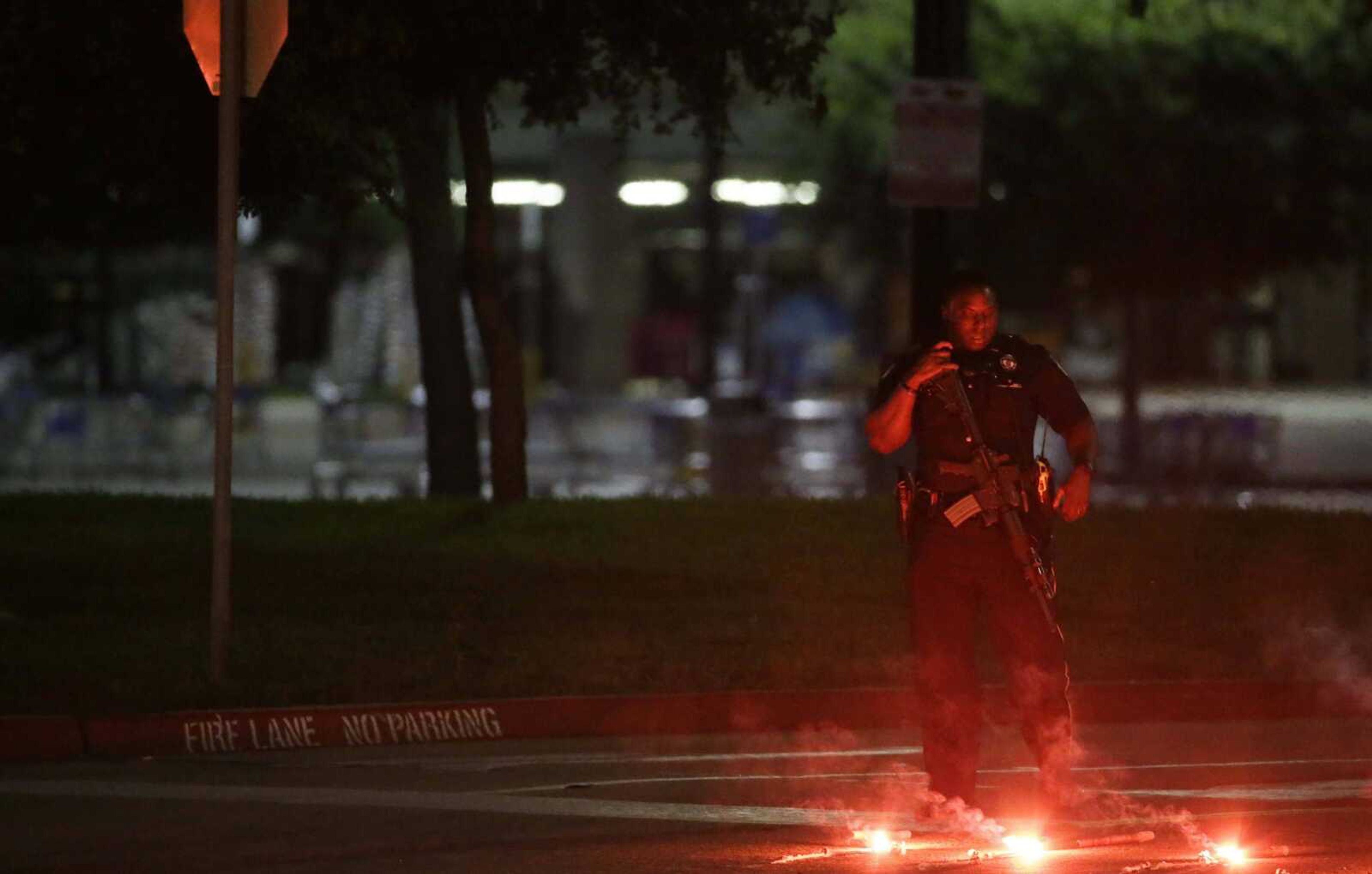 An armed police officer stands guard at a parking lot near the Curtis Culwell Center, where a provocative contest for cartoon depictions of the Prophet Muhammad was held Sunday in Garland, Texas. The contest was put on lockdown Sunday night and attendees were being evacuated after a shooting outside the building. (LM Otero ~ Associated Press)