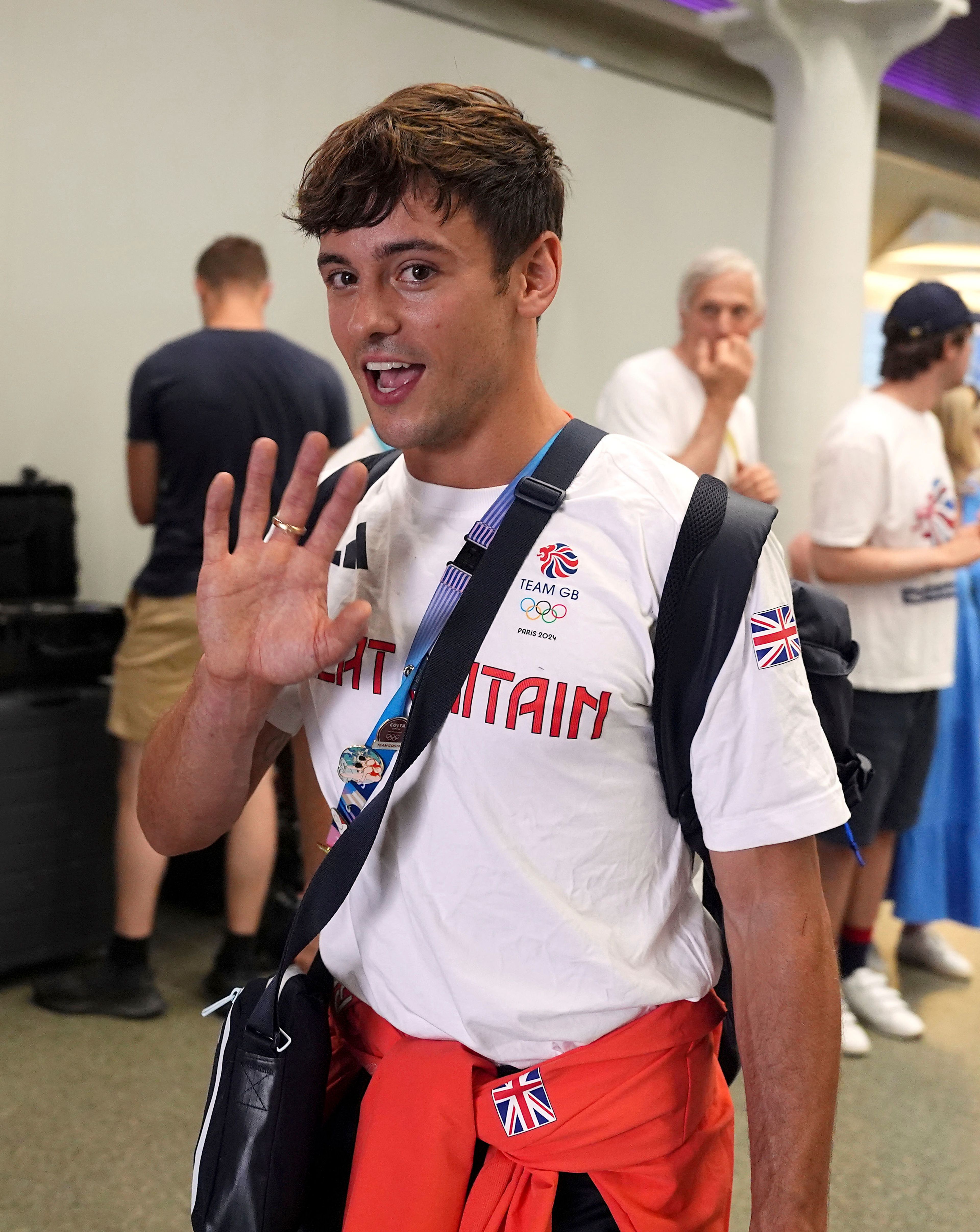 Great Britain's Tom Daley arrives by Eurostar into London St. Pancras International train station after competing at the 2024 Paris Olympic Games in France, Monday Aug. 12, 2024. Five-time Olympic gold medalist Tom Daley has announced his retirement from diving. (Jordan Pettitt/PA via AP)