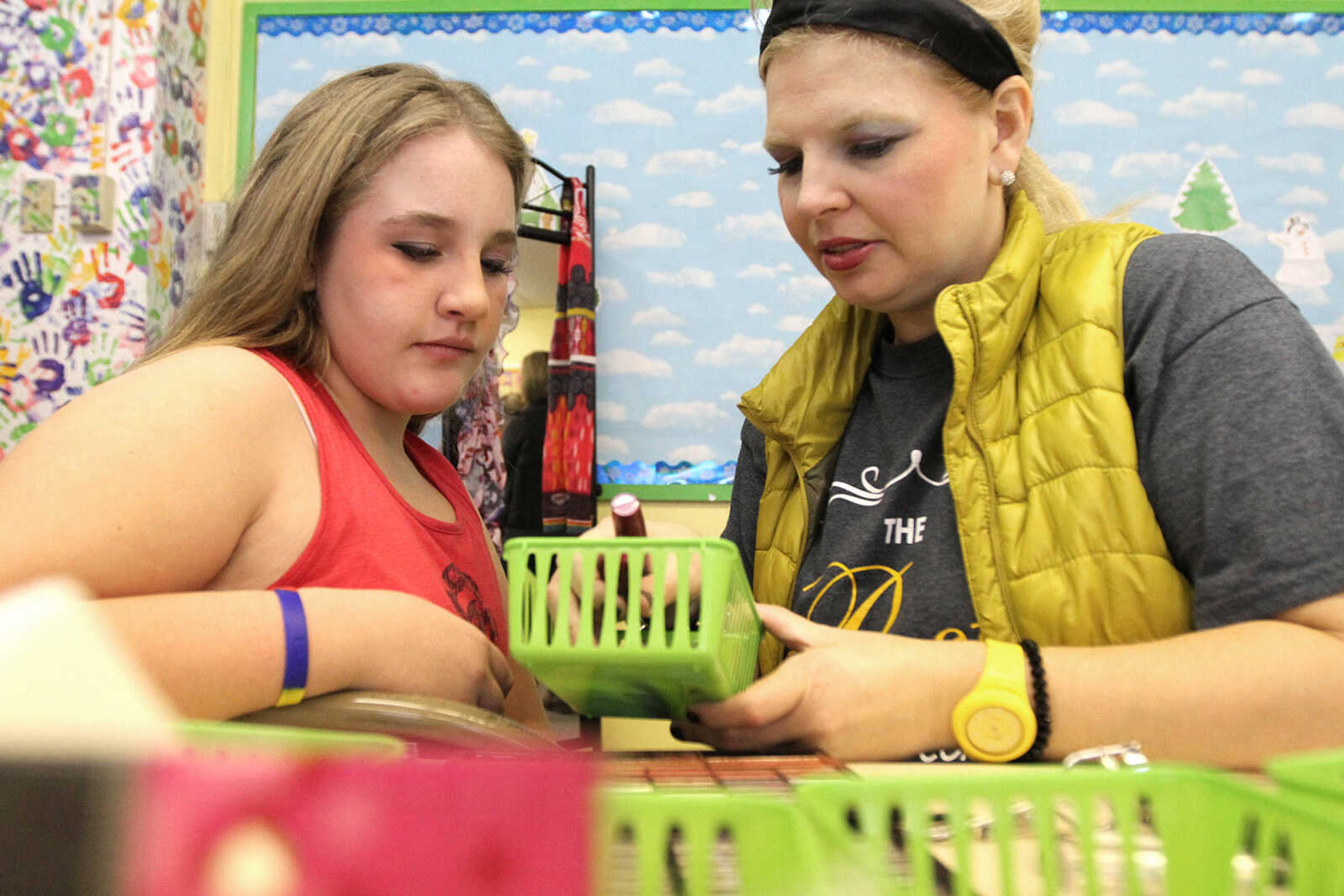 GLENN LANDBERG ~ glandberg@semissourian.com

Maddie Johnston, left, picks out lip gloss with Jenn Crass before her photo session during the fifth annual Help-Portrait event Saturday, Dec. 6, 2014 at the House of Hope in Cape Girardeau.