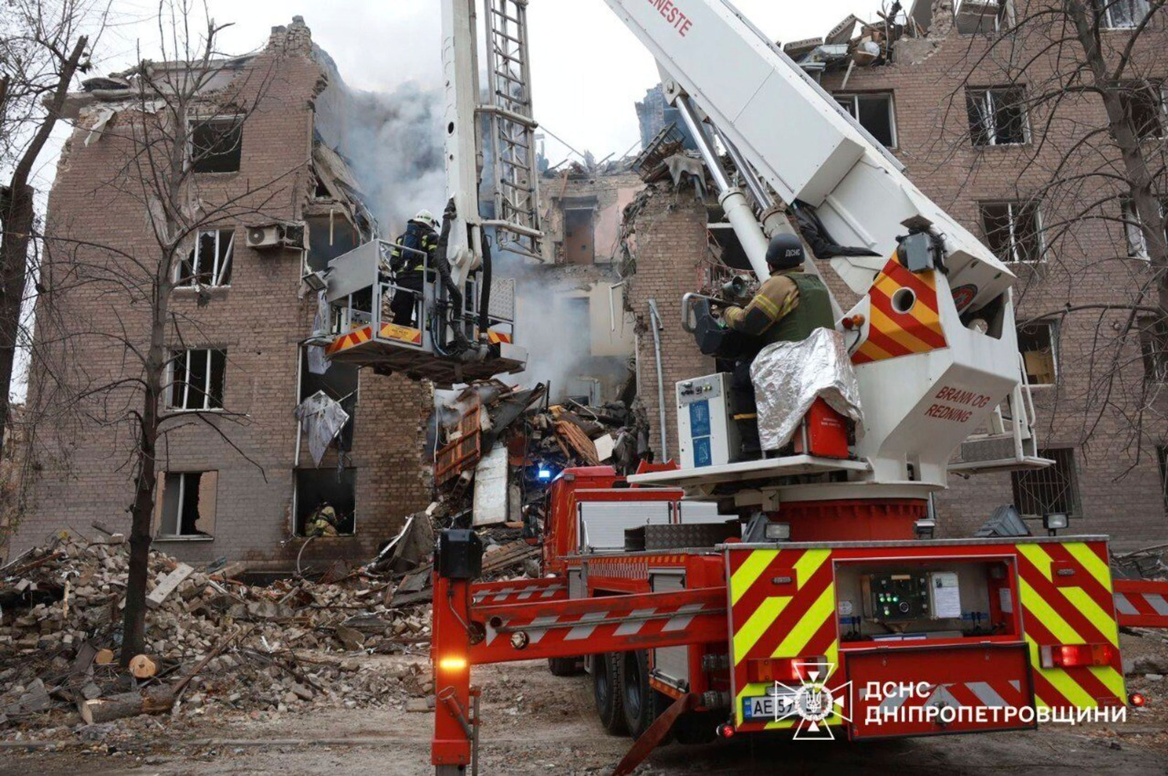 In this image provided by the Ukrainian Emergency Service on Monday, Nov. 11, 2024, firefighters work on a site of an apartments building destroyed by a Russian attack in Kryvyi Rih, Ukraine. (Ukrainian Emergency Service via AP)