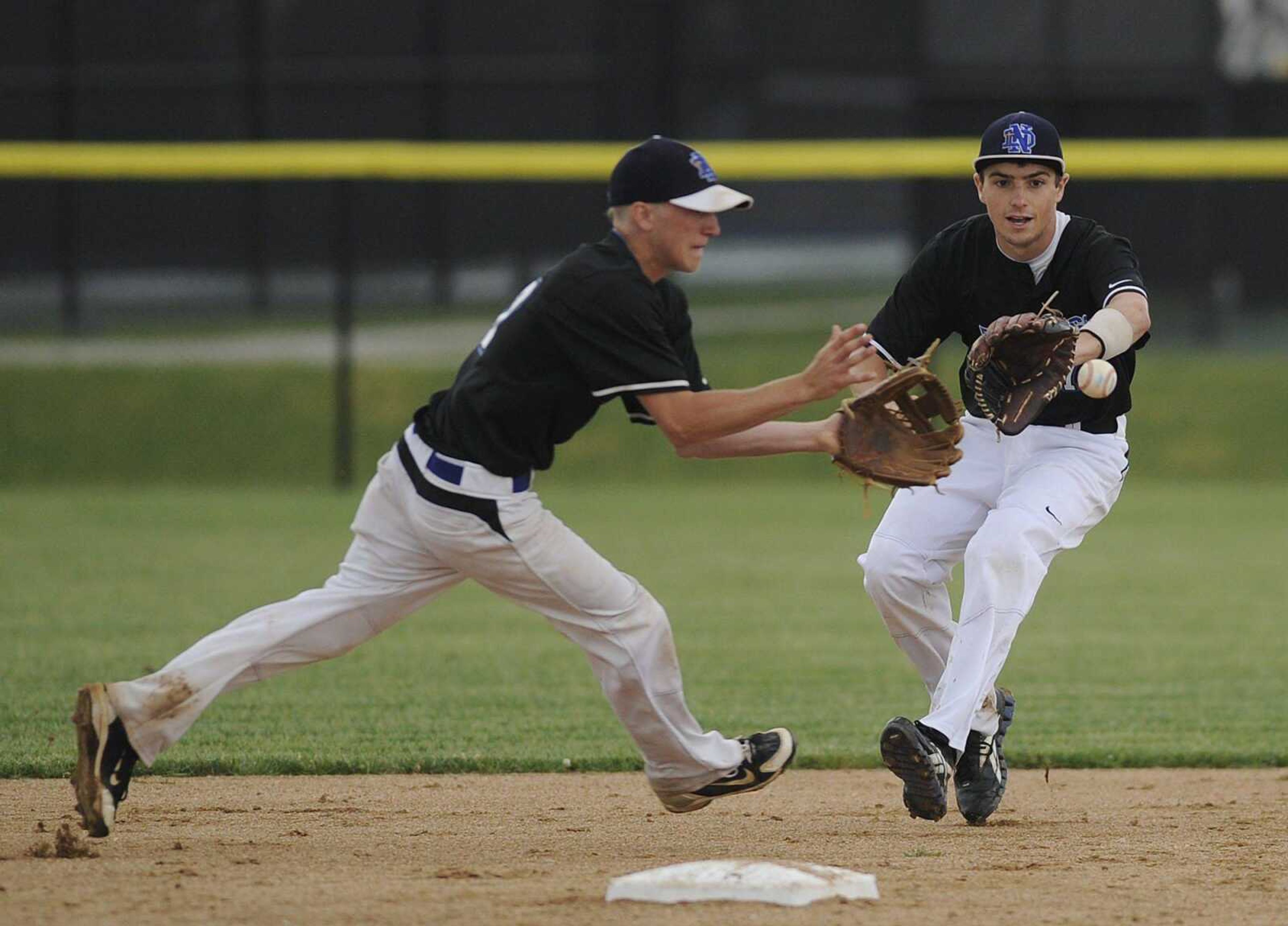 Notre Dame shortstop Justin Landewee, left, cuts in front of second baseman Griffin Siebert to field a ground ball and retire a Westminster batter during the first inning of their Class 4 quarterfinal game.