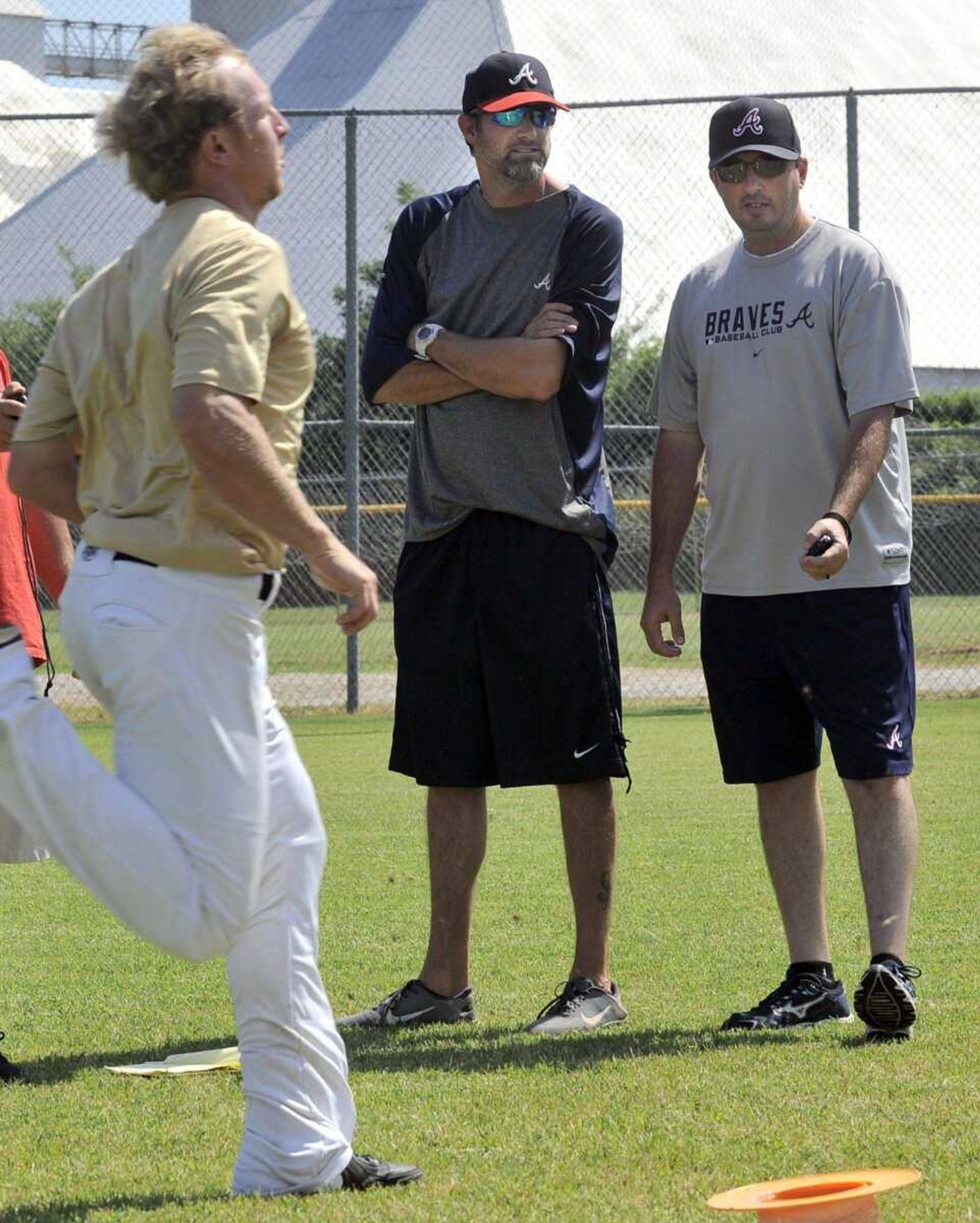 Terry Tripp, right, and Jon David French time a prospect during the Braves&#8217; tryout camp Wednesday in Kennett, Missouri.