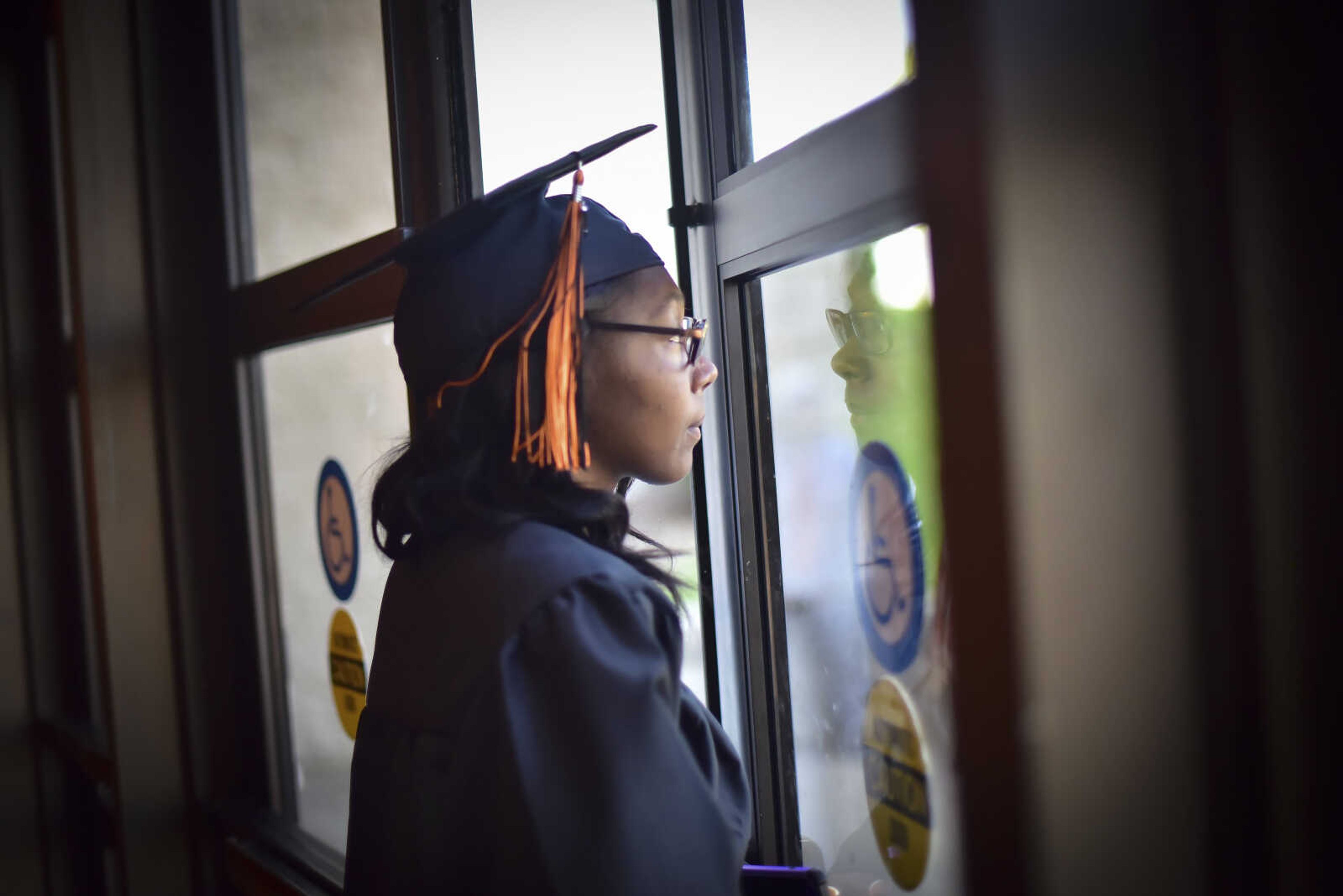 Asia Suttle stares out of the window of the Show Me Center before Cape Girardeau Central High School graduation Sunday, May 14, 2017 in Cape Girardeau.