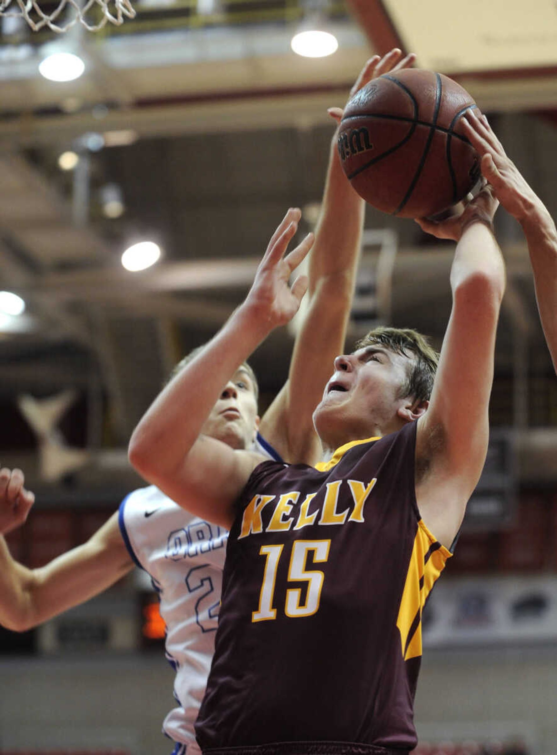 Kelly's Cayden Williams tries to shoot as Oran's Max Priggel defends during the third quarter of a consolation semifinal in the Southeast Missourian Christmas Tournament Monday, Dec. 29, 2014 at the Show Me Center. (Fred Lynch)