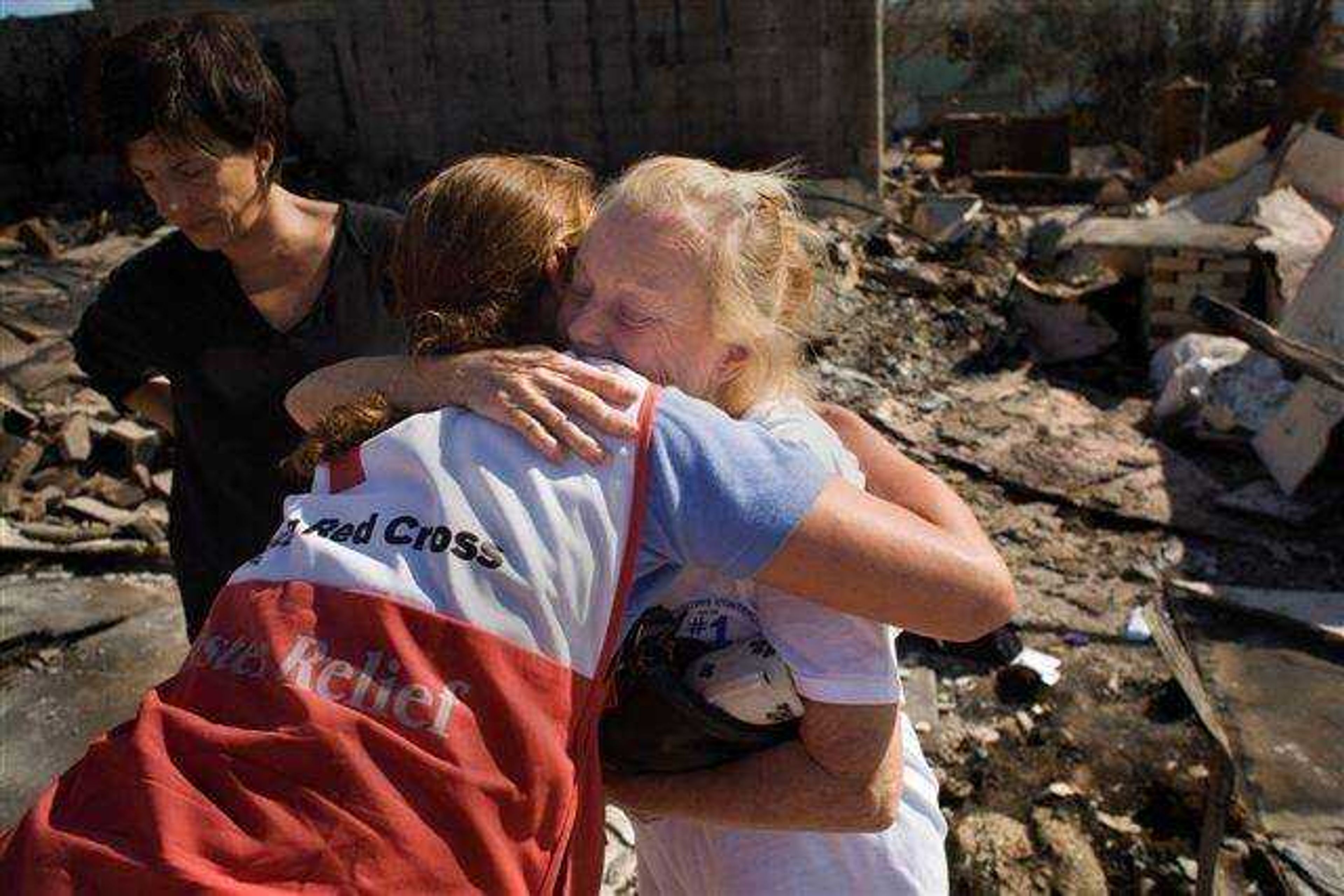 A Red Cross volunteer offers comfort and support to a fire victim.