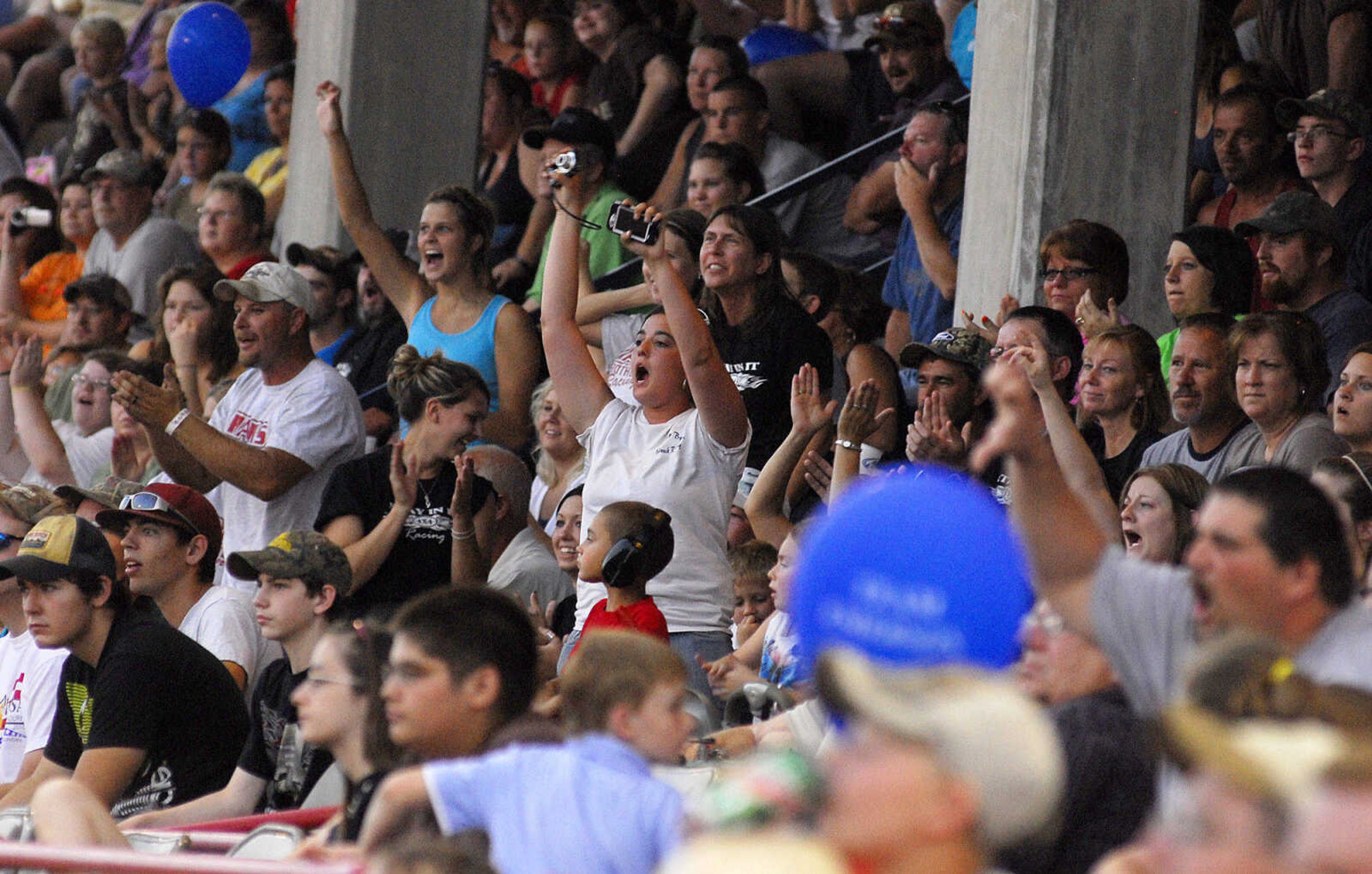 LAURA SIMON~lsimon@semissourian.com
Fans cheer for the Dual Demolition Derby during the U.S.A. Veterans Fourth of July celebration at Arena Park in Cape Girardeau Sunday, July 4, 2010.