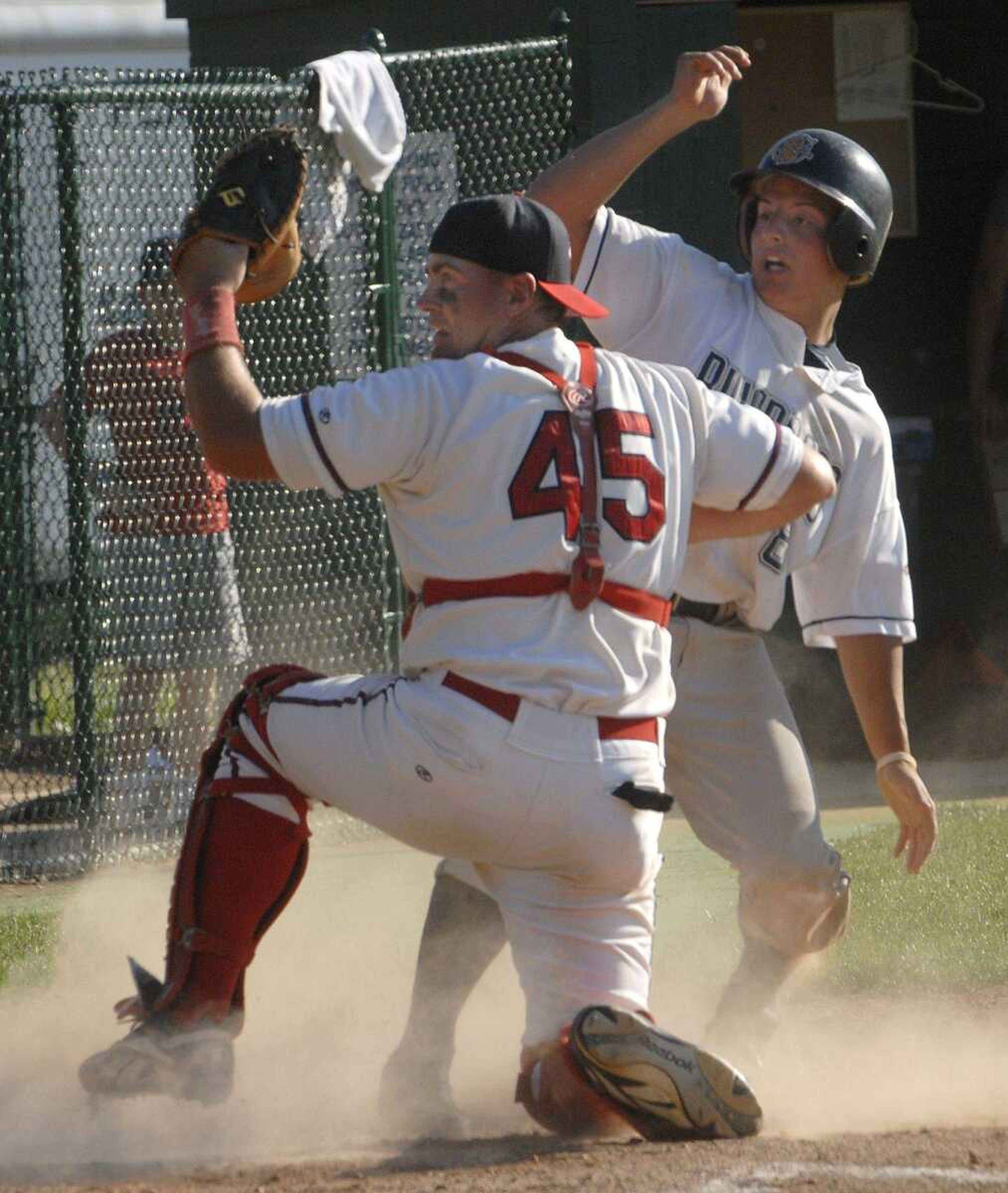 Capahas catcher John Amschler looks to the umpire after tagging out Riverdogs baserunner Caleb Daughetee during the fourth inning Sunday at Capaha Field. (Fred Lynch)