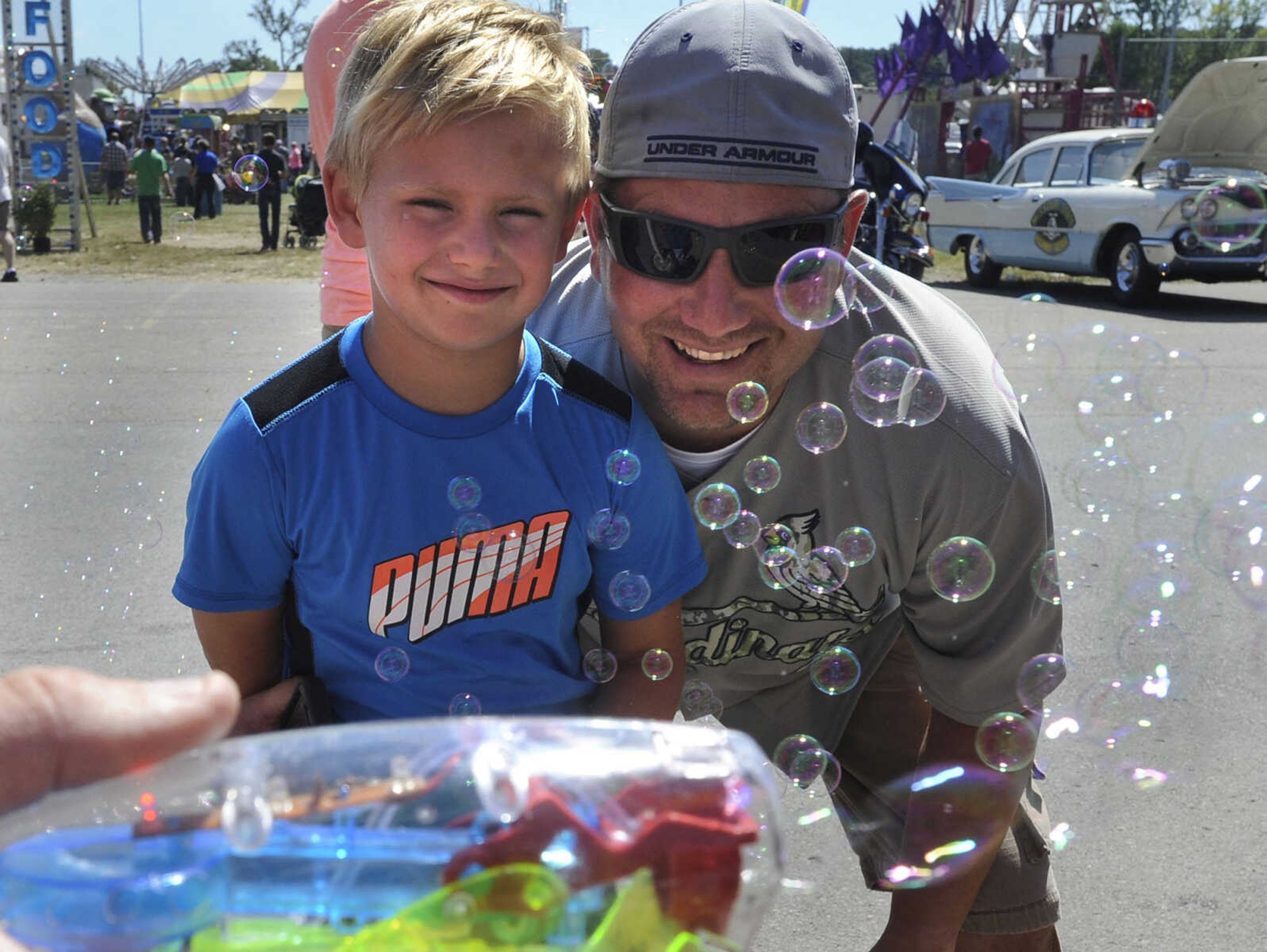 Hunter Bonham and his father, Jeff Bonham, pose for a photo Sunday, Sept. 7, 2014 at the SEMO District Fair.