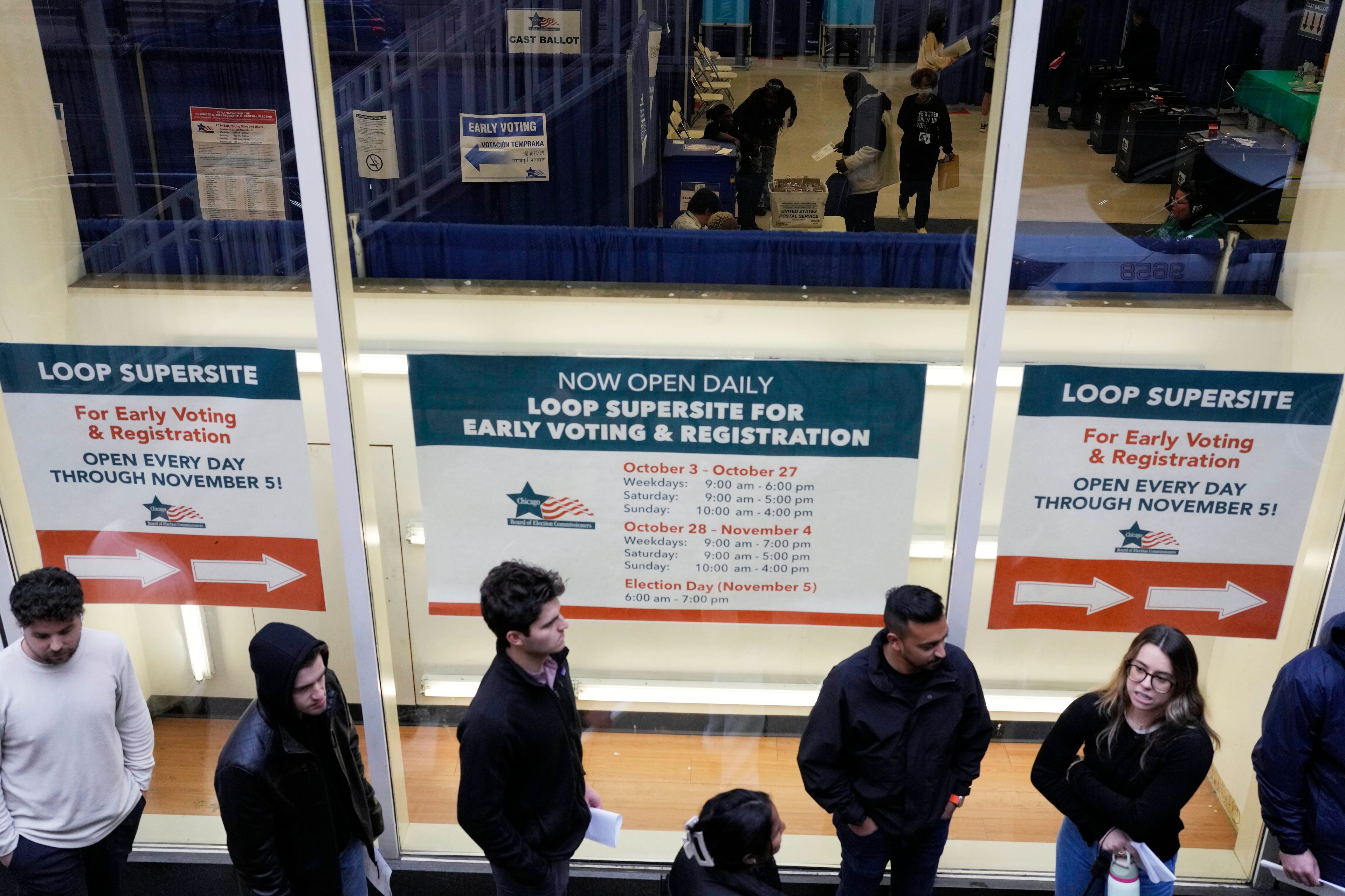 Voters wait to vote outside Chicago City Loop Super Site polling place on Election Day in Chicago, Tuesday, Nov. 5, 2024. (AP Photo/Nam Y. Huh)