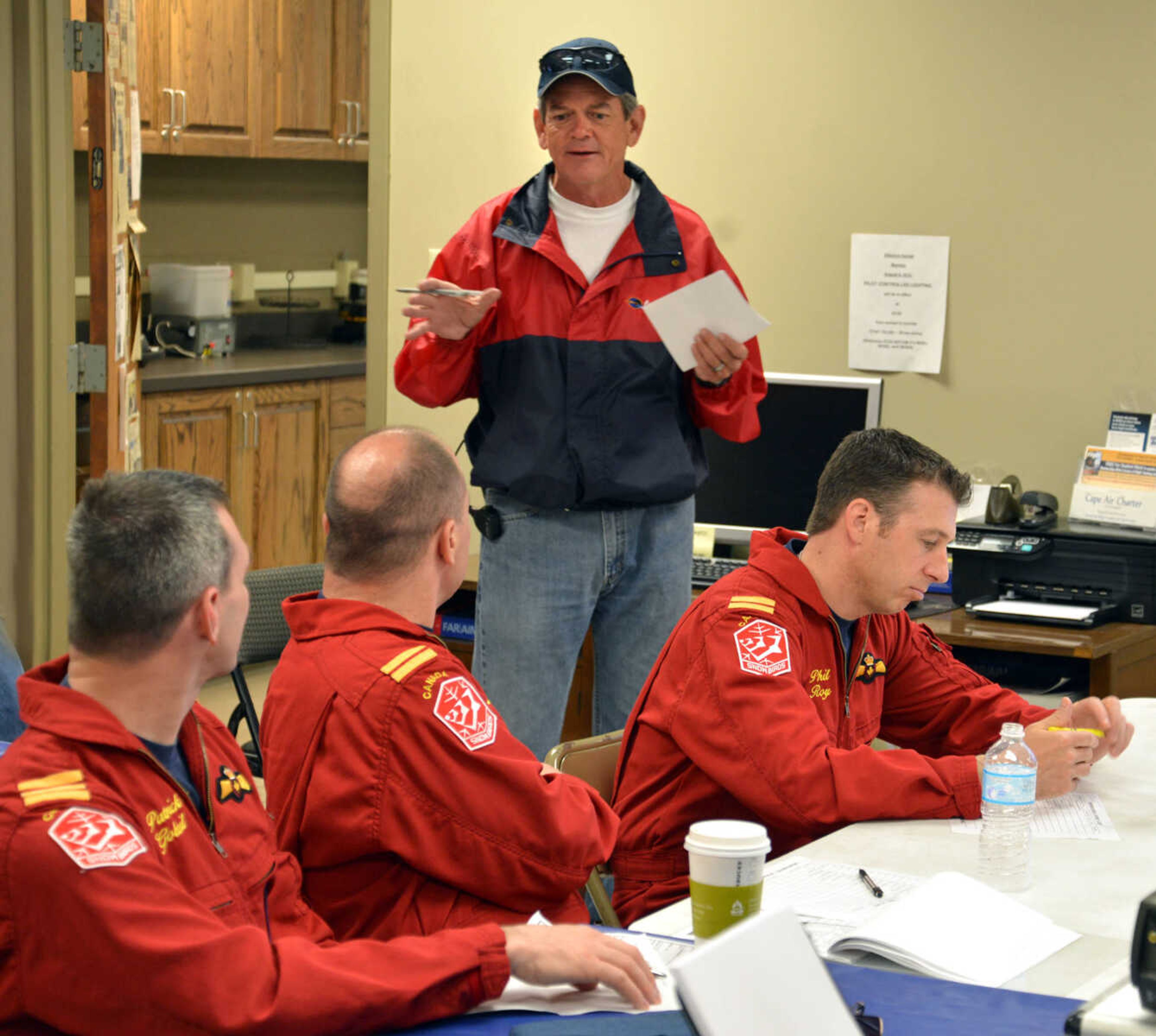 AARON HORRELL ~ photos@semissourian.com
Cape Girardeau Regional Airport manager Bruce Loy talks with Canadian Forces' Snowbirds pilots Patrick Gobeil, left, Trevor Shawaga and Phil Roy in a meeting prior to the air festival Saturday, May 17, 2014 at the airport.