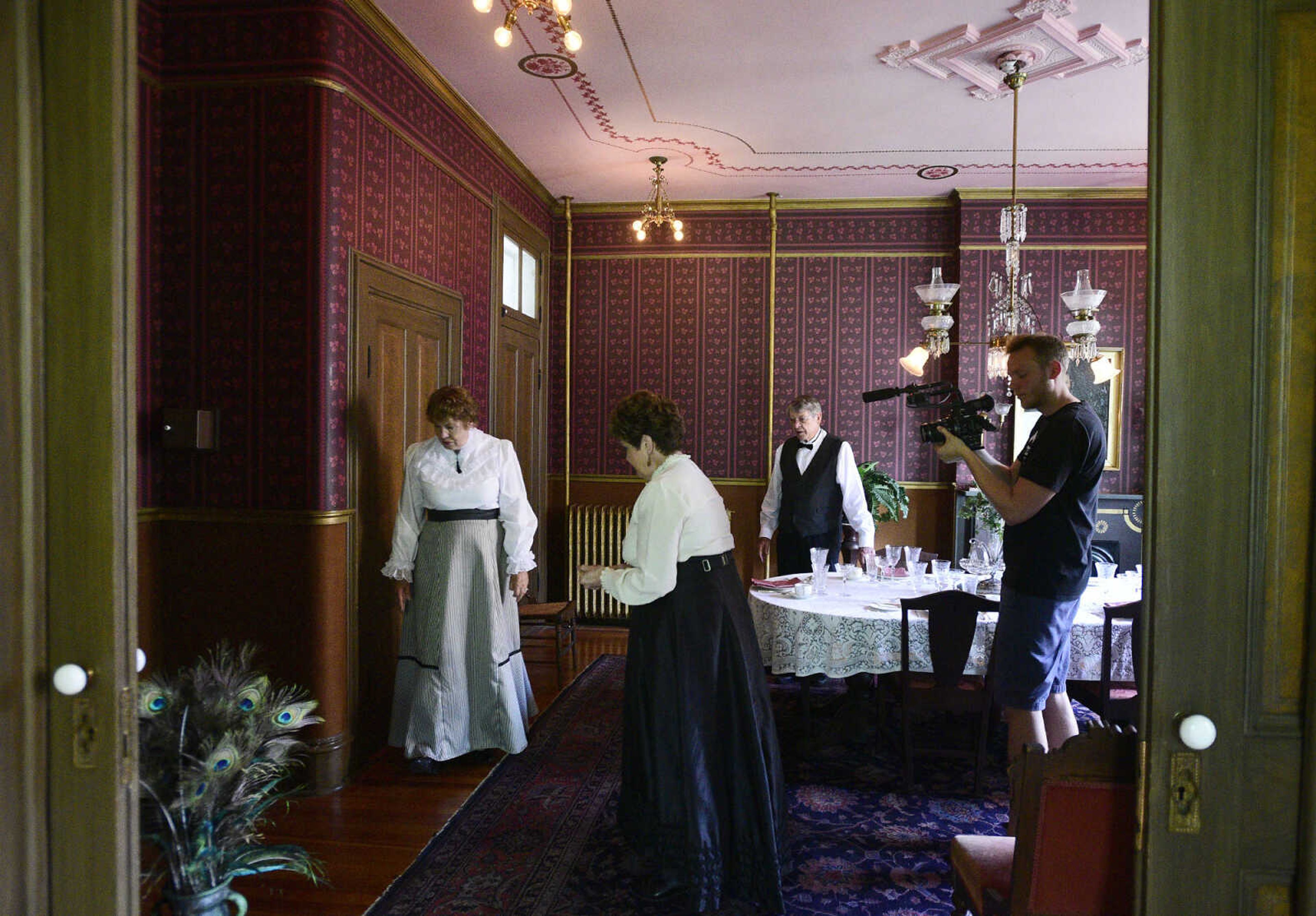 Jane Stephens, left, Mary Lou Bass and Tom Bass ad-lib a tour of the Glenn House as Eric Boedeker from KMOS-TV films them on Wednesday, Aug. 16, 2017, in Cape Girardeau. KMOS-TV, a PBS affiliate, was filming inside the historic home for its Missouri Life show.