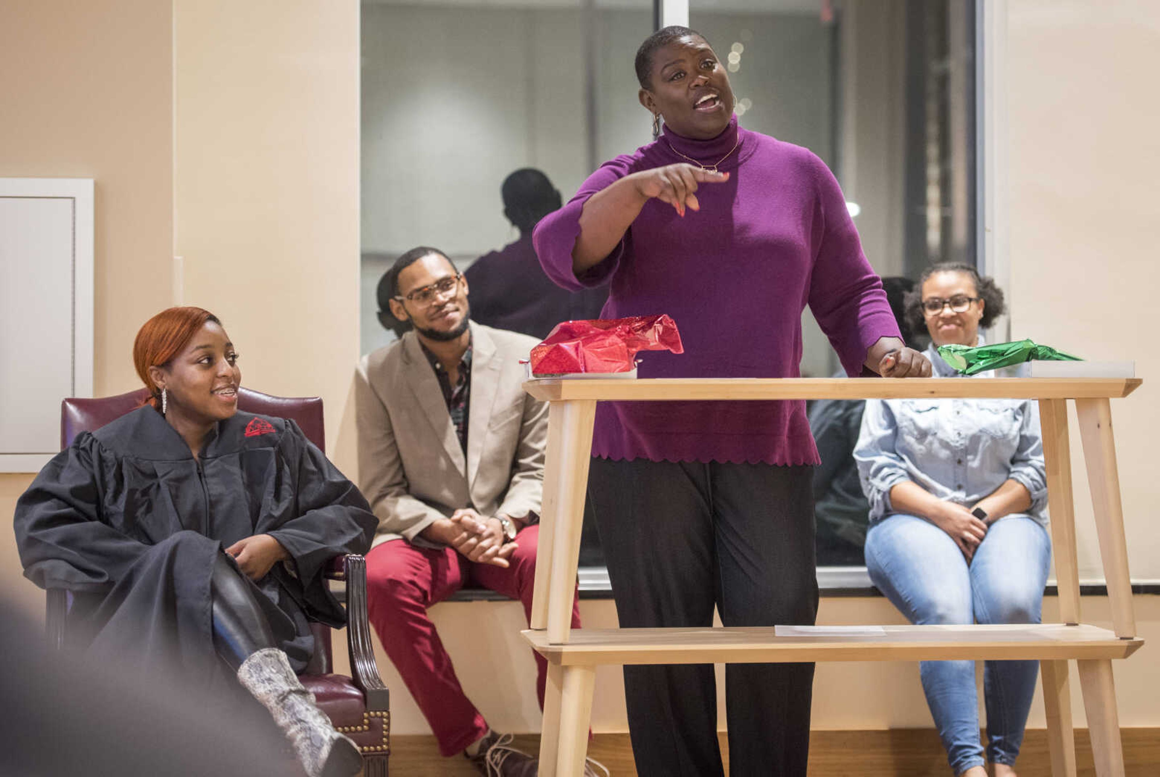 Tamara Zellars Buck shares her memories of teaching Jasmine Massey, left, during the inaugural "Donning of the Kente" ceremony Monday, Dec. 9, 2019, at Rust Center for Media, which recognized graduating members of the National Association of Black Journalists at Southeast Missouri State University in Cape Girardeau.