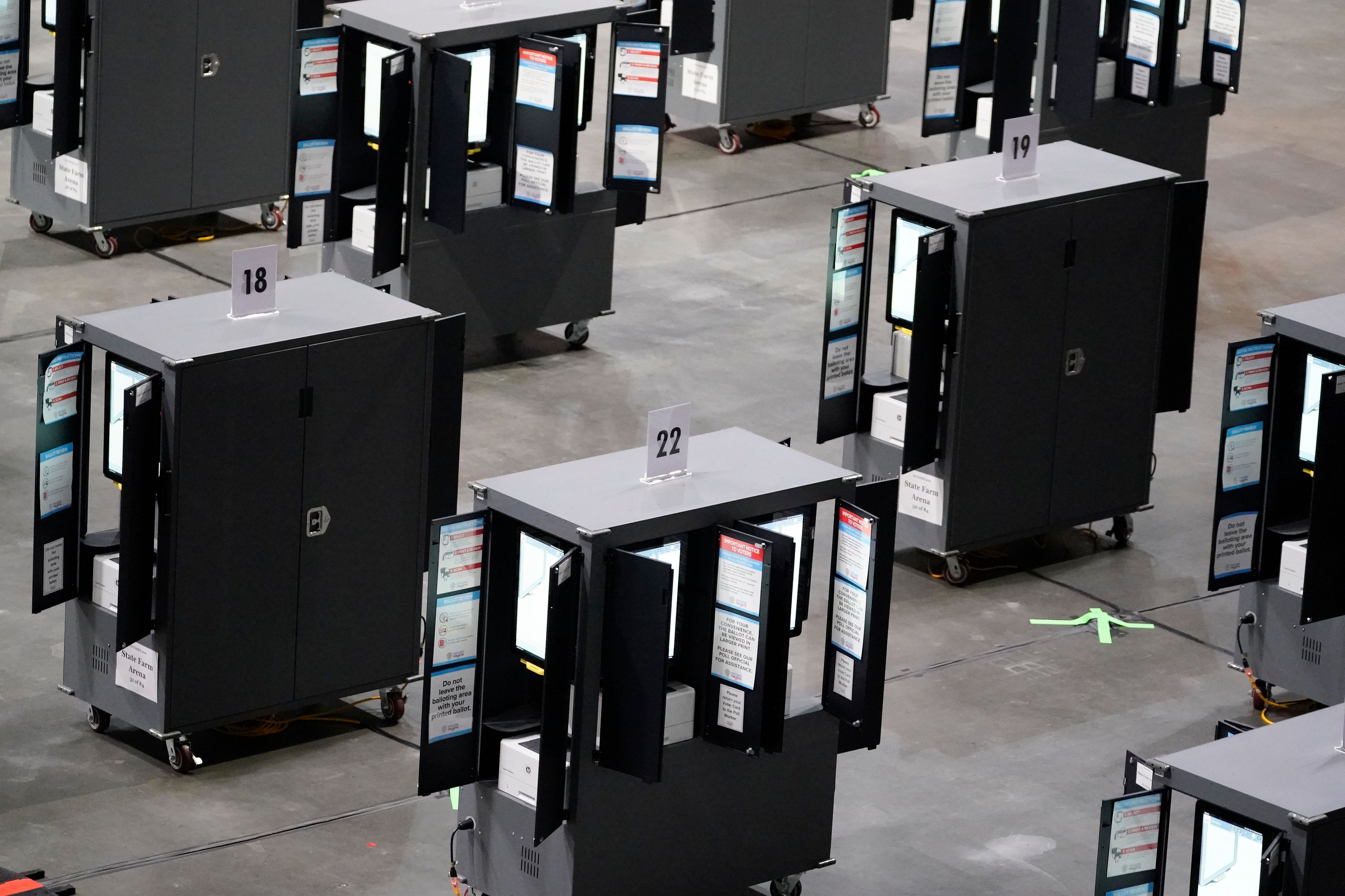 FILE - Voting machines fill the floor for early voting at State Farm Arena, Oct. 12, 2020, in Atlanta. (AP Photo/Brynn Anderson, File)