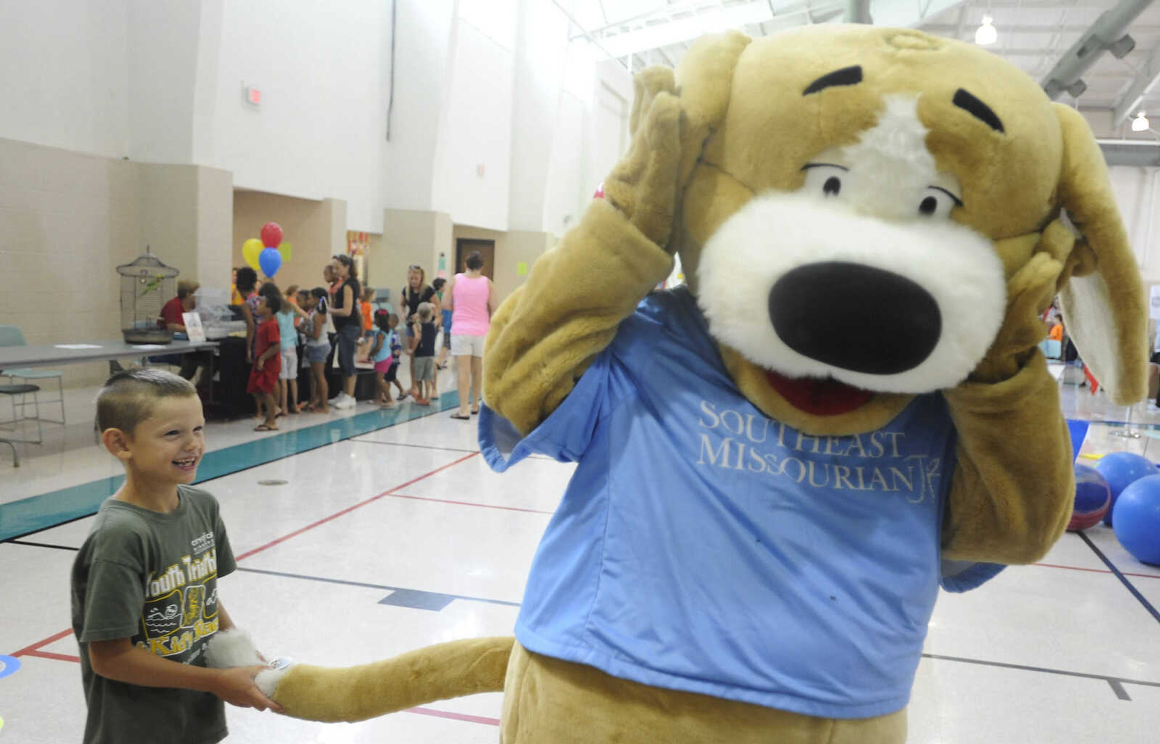 ADAM VOGLER ~ avogler@semissourian.com
Ian Roth, 7, gets ahold of Tracker's tail during the 11th annual Cape Girardeau Parks and Rec Day Friday, July 13,  at the Osage Center.