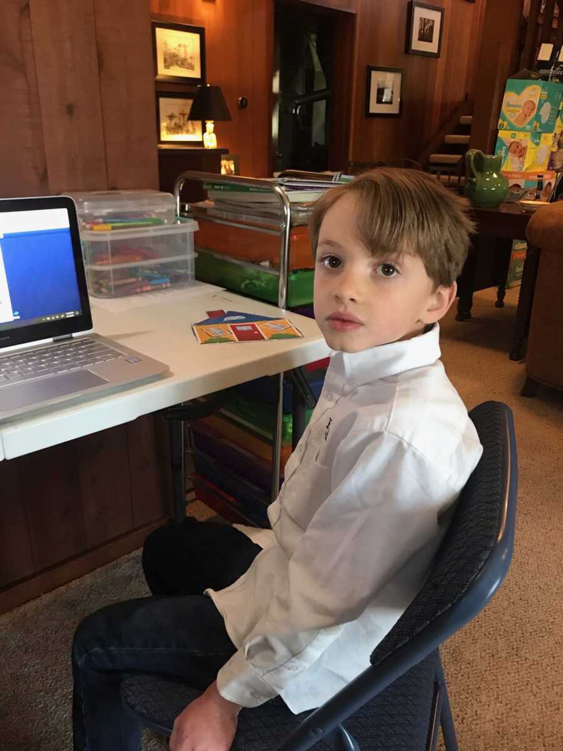 Townes Bergmann, 7, poses for a photo April 1 at his Cape Girardeau home ahead of a teletherapy session with Southeast Missouri State University's Center for Speech and Hearing.