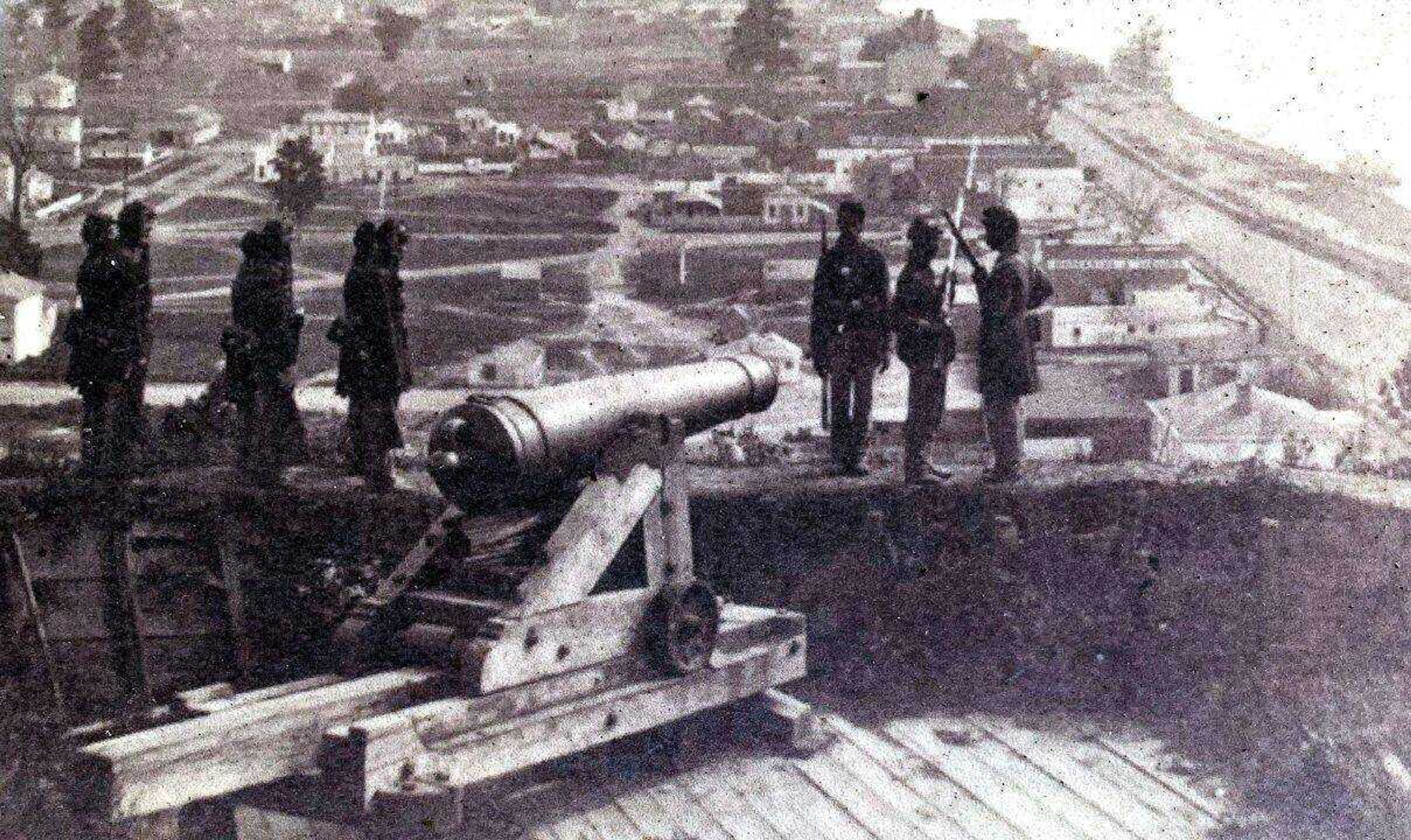 This photo appears on a storyboard at Columbus-Belmont State Park in Kentucky. Much of the original Columbus site can be seen in the background, including warehouses, docks and railroad tracks along the Mississippi River. The soldiers are members of the 4th U.S. Colored Heavy Artillery, raised at Columbus.