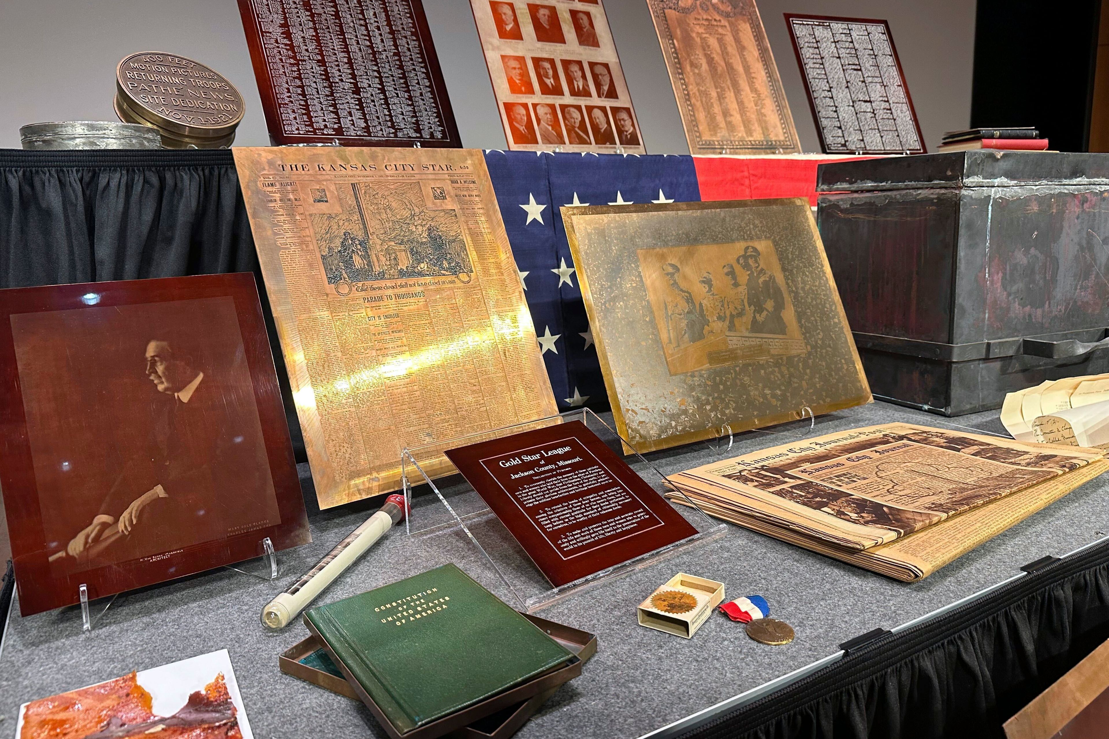 Artifacts from a 100-year-old time capsule, including metal etchings of U.S. presidents, local newspaper printing plates and a container of seeds, were revealed to the public by the National World War I Museum and Memorial on Wednesday, Oct. 16. 2024. in Kansas City, Mo. (AP Photo/Nick Ingram)